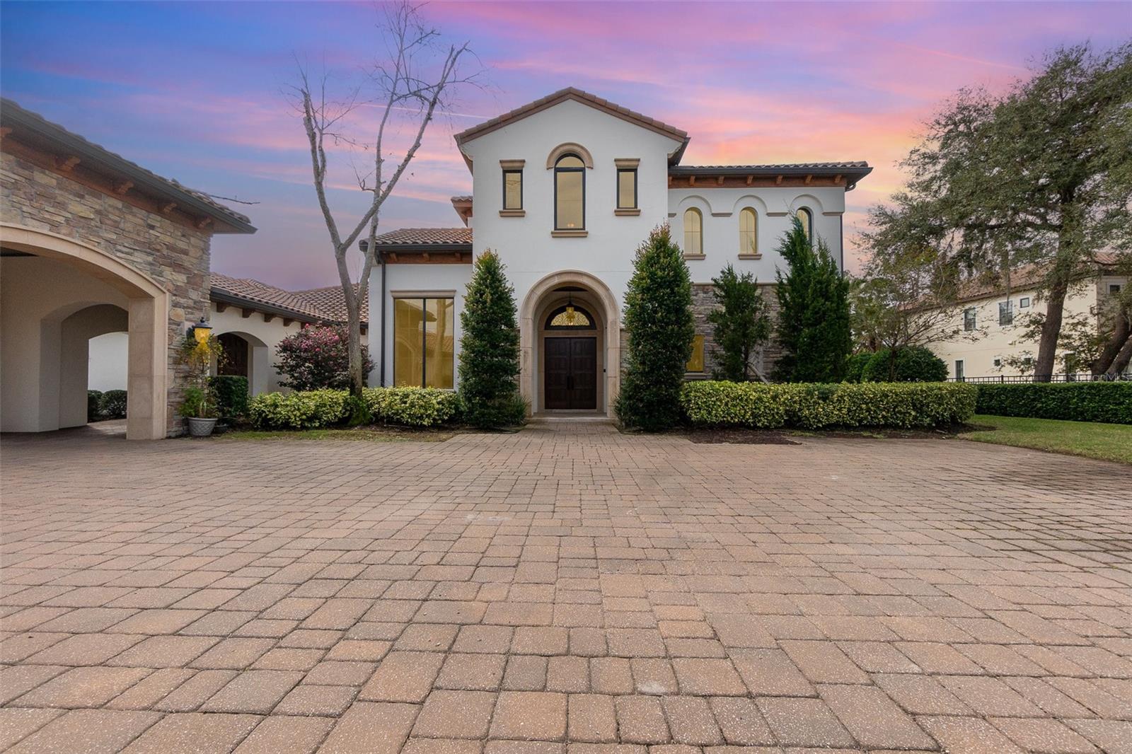 One or more photo(s) has been virtually staged. Welcome to Your Dream Home!
This stunning 4-bedroom, 4.5-bathroom estate with an oversized 6-car garage is a private gated retreat nestled in the beautiful Lake Nona area. Set on an expansive 2.5-acre lot with over 6,200 sqft of meticulously crafted living space, this home offers unparalleled luxury, elegance, and functionality.
Interior Features: • Gourmet Chef’s Kitchen: A culinary masterpiece featuring stainless steel appliances, granite countertops, custom cabinetry, a hidden pantry, and a spacious island. • Luxurious Primary Suite: Located on the second floor, the primary suite offers a custom-built walk-in closet with a secondary laundry area and clothes steamer, stunning wood-beamed ceilings, and a spa-like ensuite with dual vanities, a makeup station, jacuzzi tub, and walk-in shower. Step onto your private balcony and savor breathtaking sunsets over Lake Whippoorwill. • Open Floor Plan: Sunlit living and dining areas boast soaring ceilings and panoramic waterfront views. • Additional Features: A secondary primary suite on the first floor, elevator, motorized boat lift dock, jet ski dock, and an oversized 6-car garage with a built-in workstation, outdoor kitchen, and a hidden safe room.
Exterior Features: • Lakeside Living: Relax on the covered lanai or private dock, enjoying tranquil views of Lake Whippoorwill. • Professionally Manicured Grounds: The lush landscaping creates a serene and picturesque setting.
Prime Location: Conveniently located just minutes from Disney, top-rated schools, world-class shopping, dining, and major highways, this home perfectly balances luxury and accessibility.
Don’t miss your chance to own this waterfront masterpiece in one of Orlando’s most sought-after neighborhoods. Schedule your private showing today!
