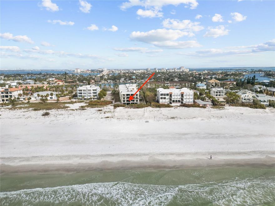 Indulge in the epitome of coastal luxury with the ONLY FULL GULF FRONT condo listed in Pass-a-Grille. Perfectly blending beachfront serenity with a boater’s dream, this rare gem includes a PRIVATE DEEDED BOAT SLIP, offering unmatched access to both the Gulf of Mexico and the Intracoastal Waterway.
EVERY room in this exquisitely designed condo boasts breathtaking views the Gulf of Mexico and the iconic Don Cesar. Its unique, grandfathered location, closer to the shoreline than modern developments, provides a rare sense of privacy and connection to the water. This condo has no busy street in front as most Pass-a-Grille condos do, only sand, beach and water.
Step inside and be captivated by the expansive beachfront vistas visible the moment you walk through the door. The oversized balcony provides unobstructed views stretching down the coastline, making it the perfect place to catch a sunset.
This fully furnished, turn-key condo has been meticulously renovated and is move-in ready. The spacious primary suite features large sliders looking out to the Gulf of Mexico, his-and-hers closets, and a stunning en-suite bathroom. The guest bedrooms offer views of the Don Cesar and Gulf of Mexico as well as large walk-in closets and share a beautifully updated Jack-and-Jill bathroom.
With direct beach access, a private boat slip, and two assigned parking spaces—an incredibly rare convenience in this area—this condo truly offers a one-of-a-kind luxury lifestyle. This luxurious community offers enhanced privacy with a coded elevator, a sparkling waterfront pool, and a large shared dock. 
Whether you’re soaking in the Gulf views, stepping out onto the sand, or cruising the waterways in your boat, this condo offers a seamless blend of elegance and adventure.