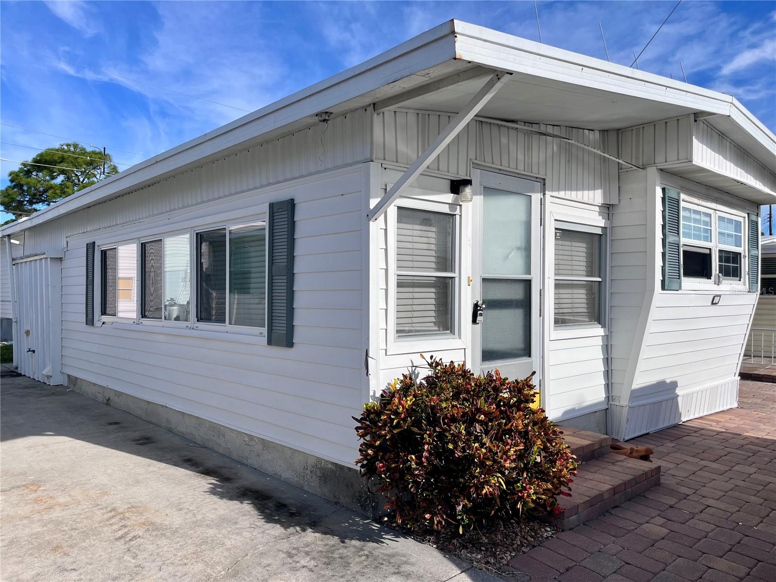 Location says it all. Come and buy your piece of paradise. This home is ready to be put back together. Needs some drywall, painting, a BA vanity, and small kitchen inside. And some minor touchups outside since the previous hurricane season. The small size indicates a short turn around time to complete. Home offers a laundry room and a screened porch. You could be spending this coming winter season in paradise at Paradise Bay. Sellers reluctantly letting it go, they made many memories here in the past decade of ownership. Spending their winters in the Florida sunshine, by the pool, at the beach, and sunset walks on sarasota bay. Community has a heated pool/spa, private boat ramp, pickleball, shuffleboard & bocce courts, exercise room, horseshoe pit, gazebos and seating areas along the water and a recreation hall w/social calendar. Now it is your turn. Make this adorable retro mobile home beautiful again. Only 2 miles to AMI....great for bike riding or cruising in your golf cart. Lots of community morale in the park, especially during the seasonal winter months. 55+