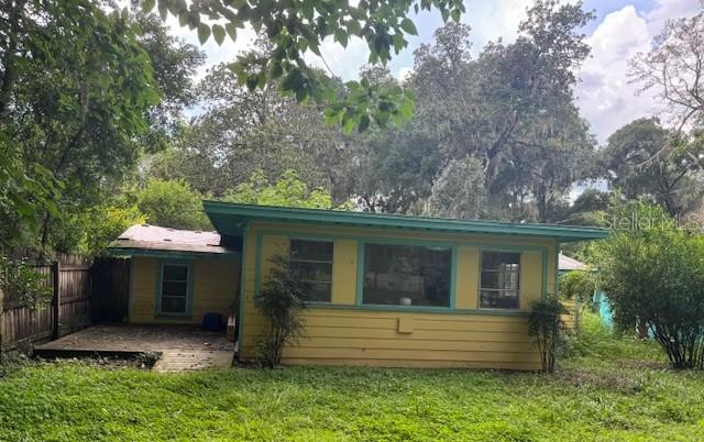 Looking for a weekend getaway, income property, or your very own old-Florida fish camp? This 2 bedroom, 1 bathroom home is full of potential and waiting for the right touch. Located just one block from Newnan's Lake. This 1950-built cottage sits on a fenced yard with mature fruit trees, including lemon, satsumas, pear and fig trees. You will enjoy plenty of outdoor space for a garden, boat parking, or relaxing under the shade.