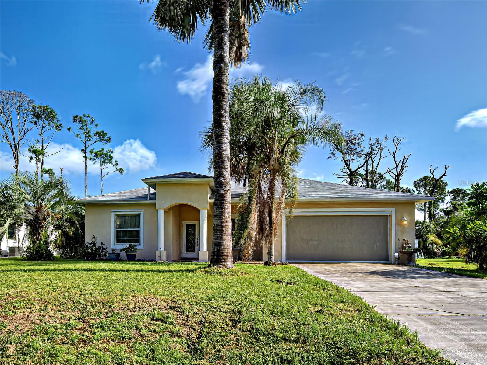 PRICED TO PLEASE, BELOW MARKET VALUE, IN AREA OF NEW CONSTRUCTION AND MUCH HIGHER PRICED HOMES! YOUR FAMILY IS ALL THAT'S NEEDED TO FILL THIS well-cared-for 2000 SF 3-bedroom + den/office, with formal dining room + breakfast bar in kitchen, blending seamlessly into light, bright, open family room, making entertaining a breeze. Great curb appeal, with stately columns, tiled front porch and leaded glass front door. Character and charm abound throughout, with intricate architectural detailing and quality workmanship! Tray ceilings in formal dining room, den/office and spacious master bedroom (with up-lighting), lush carpet and two walk-in closets! Master bath with double granite-topped vanities, garden tub and step-in shower! Step directly out of the master bedroom onto the huge tiled, screened lanai, with extended outdoor patio, overlooking the lushly landscaped back yard with two storage sheds, and THERAPEUTIC "ENDLESS POOLS" FIBERGLASS SWIM SPA/HOT TUB INCLUDED (8-1/2' X 18' X 5' tall, 5 hp swim current generator with 2 wireless remote controls, seats one swimmer and 4 adults, 3 powerful river jets and 26 adjustable spa jets, solar cover, mahogany maintenance-free synthetic skirting). H-U-G-E inside laundry room/butler's pantry, with lots of nooks and crannies for storage (shelves, cupboards and counters). Washer and dryer (new in 2019) included! Oversized two-car garage with screened entry, work benches and numerous cabinets! NEW ROOF (2024). NEW Culligan water system! Security system. Irrigation system. See-through hurricane shutters! Sellers offering Home Warranty for added peace of mind! Some furnishings and collectibles negotiable! Minutes from world-class fishing, boating, golf, restaurants, shops, medical facilities and top-rated schools! NOT IN FLOOD ZONE! NO HOA or CDD! NO DEED RESTRICTIONS!