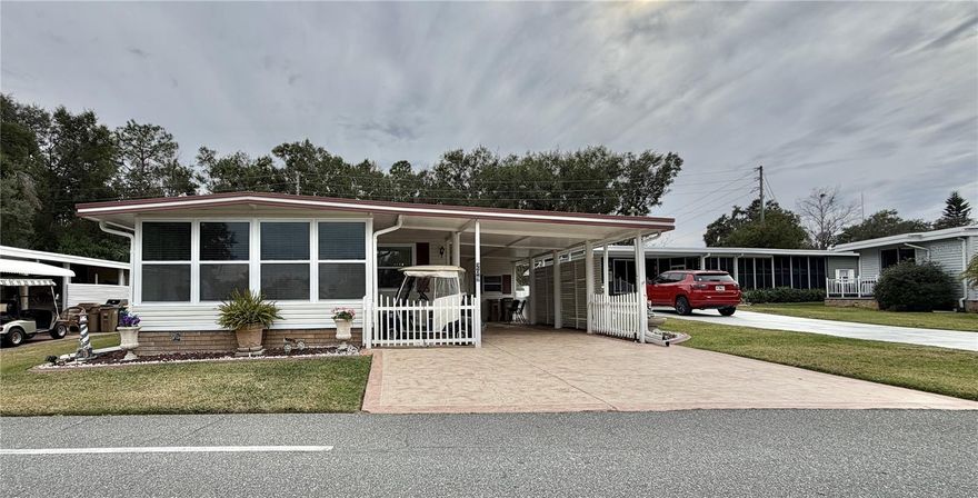 A truly unique opportunity to own a home on Hawthorne Boulevard, perfectly positioned across from sweeping views of the fountain lake and the beautiful clubhouse. Tucked against a tranquil woodland backdrop, this fully furnished residence offers a rare blend of refinement, comfort, and quiet escape.



The home features two serene bedrooms plus a versatile bonus room that can easily serve as a third bedroom, studio, or cozy den, thoughtfully arranged to embrace both function and flow.



Inside, recent enhancements elevate every corner, from the smooth drywall walls to the luxury vinyl plank flooring that lends warmth and continuity throughout. Sunlight filters through new windows, highlighting the upgraded kitchen where handsome cabinetry, refined countertops, built-in storage, recessed lighting, and an elegant drop light create an inviting heart of the home. Fully equipped and beautifully appointed, it is a space designed for both everyday ease and memorable gatherings.



The bathrooms feel indulgent and artfully finished, featuring beautiful vanities and refined countertops paired with walk-in showers enclosed by sleek glass doors. Tiled walls and floors are accented with carefully curated details, creating a spa-inspired atmosphere.



Adding to the home’s exceptional versatility is an additional climate-controlled room located next to the laundry area, complete with heat and air. This flexible space is ideal for an office, storage, or workshop, offering comfort and functionality year-round.



Practical upgrades provide lasting assurance, including a newer HVAC system (2018), a water heater (2025), and a washer (2025). Outdoors, a brick-tiled back porch overlooks the woods, creating a peaceful haven for morning coffee or evening reflection.



Completing the picture are vinyl siding, a freshly painted driveway, pebble-finish accents, recessed lighting, a termite bond, and a golf cart included for effortless community living. This is more than a home, it is a welcoming retreat where scenic views, modern upgrades, and natural serenity come together beautifully...........Hawthorne at Leesburg is an active, resident owned, 55+ cooperative, waterfront, gated community, with beautifully landscaped grounds, lakes with illuminated fountains and a relaxing and comfortable gazebo. The affordable monthly maintenance fee of $397 includes water, sewer, lawn mowing, private emergency services and storage space for recreational vehicles, boats, trailers and much more! The beautiful clubhouse is complete with a full-time program coordinator, more than 100 different activities and seating for 550. It has a hospitality lounge, card rooms, craft rooms, billiard room, fitness center, library, fine arts room and many more. There is excellent fishing, outdoor geo-thermally heated pool and two enclosed therapeutic pools. Hawthorne boasts a private marina monitored by an electronic security system with over 120 boat slips and access to the Harris Chain of Lakes and beyond.