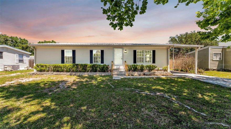 One or more photo(s) has been virtually staged. Welcome to 4927 Rollinglen Loop in Lakeland—where thoughtful updates, natural light, and outdoor living come together beautifully. From the moment you arrive, you’ll notice the fresh landscaping, metal roof, and the expansive oversized lot featuring a carport, storage shed, and a fully fenced backyard—perfect for privacy, pets, and play. Step inside to a bright and inviting interior filled with natural light streaming through oversized windows. The home showcases fresh paint throughout, new flooring, and updated baseboards that provide a clean, modern feel from room to room. Ceiling fans, light fixtures, and smoke detectors add both style and peace of mind. The kitchen has been refreshed with updated cabinetry, solid surface countertops, and stainless-steel appliances, offering both functionality and a contemporary look. Just off the main living areas, you’ll find a convenient inside laundry space. The guest bathroom was previously remodeled with a new vanity, toilet, and updated fixtures—designed with both comfort and style in mind. The primary bedroom offers its own upgrades, including an en suite, creating a private and refreshed retreat that includes a beautifully tiled shower. With its move-in-ready condition and exceptional outdoor space, this home offers the perfect blend of comfort, style, and functionality—all in a convenient Lakeland location. Don’t miss your opportunity to make this beautifully updated property your next home!