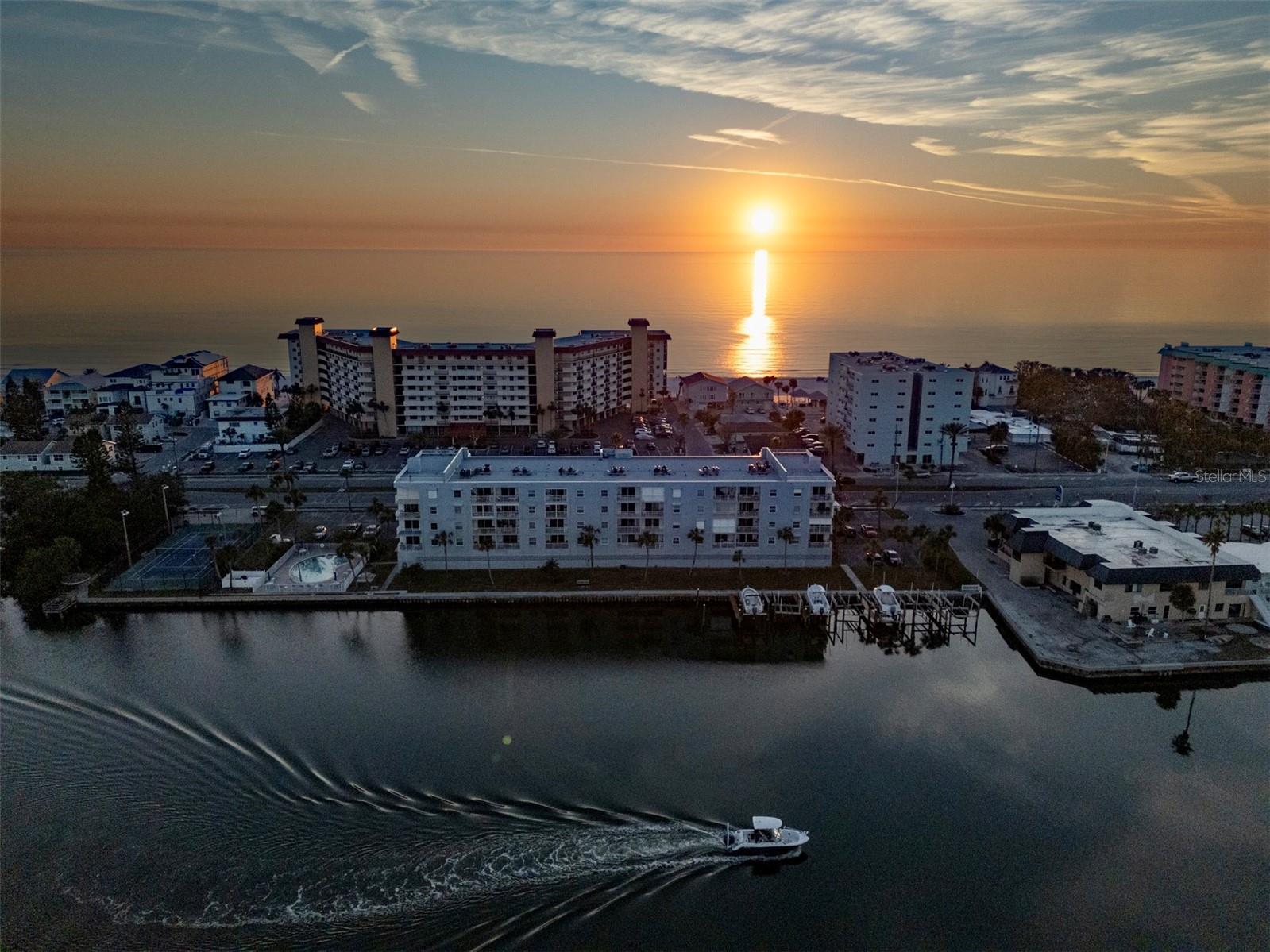 One or more photo(s) has been virtually staged. Live the coastal lifestyle! Welcome to Portside Condos, a hidden gem along the Intracoastal Waterway with just 36 residences, offering a charming and intimate community feel. This spacious 2 bedroom, 2 bathroom condo is a blank canvas, ready for you to transform into your ultimate beach retreat! Enjoy peace of mind with a brand-new HVAC system, fresh interior paint, and new ROOF! Take in the gorgeous sunrises while sipping your morning coffee on your private balcony. Overlooking the serene waters; you’ll love watching the boats glide by and dolphins play! Conveniently located to the right of building is the Town of Redington Shores tennis/pickleball courts. For some fun in the sun, challenge a friend to a match, then unwind with your favorite cocktail or get lost in a good book by the pool - the perfect way to relax and enjoy the coastal breeze. With public beach access directly across the street, you’re just steps from sinking your toes into the sugar sands of beautiful Redington Shores Beach. Enjoy taking a walk along the shore, soak in the breathtaking views and watch as the sun sets over the horizon. Additional features include assigned covered parking under the building for owners and ample parking spaces for guests, elevator, trash chutes and a secured lobby. HOA fee includes; water, sewer, trash, cable and internet for added convenience. Within a short distance you will find a playground, public boat ramp, shopping, restaurants, water sports, and much more! This is a rare opportunity-bring your creativity and make this condo uniquely yours! Schedule your showing today!