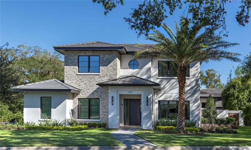 Location meets beauty and state-of-the-art convenience in this impressive Winter Park home. Built in 2017 by Maroon Fine Homes, this home features a long-lasting concrete tile roof and stone tile accents combined to create a stately first impression. Hardwood floors greet you at the front door, bringing a warm elegance to all common areas throughout the home. Large clad windows let in plenty of light. The windows feature insulated & argon-filled glass with Low-E coating.  The tankless water heater runs on natural gas and the high-efficiency Carrier heat pumps work together to lower energy costs in hot or cold weather. The bright and open kitchen features granite countertops,  all-wood custom-built cabinets by AWR Cabinetry, Thermador appliances, and a Sub-Zero wine cooler. In every bath, you’ll find beautiful, durable porcelain tile, as well as plenty of under-sink storage. Keypad controlled audio visual, security and Lutron lighting system puts the ultimate in convenience at your fingertips. The covered back porch with travertine pavers extends the livable space outside for comfortable lounging, swimming in the inviting rectangular pool, dining al fresco or gathering with friends around the firepit. This lovely home is conveniently located just minutes from Central Park and the stylish boutiques and diverse restaurant offerings of the Park Avenue shopping district.  Note: Pictures were taken in 2017 by original owner.