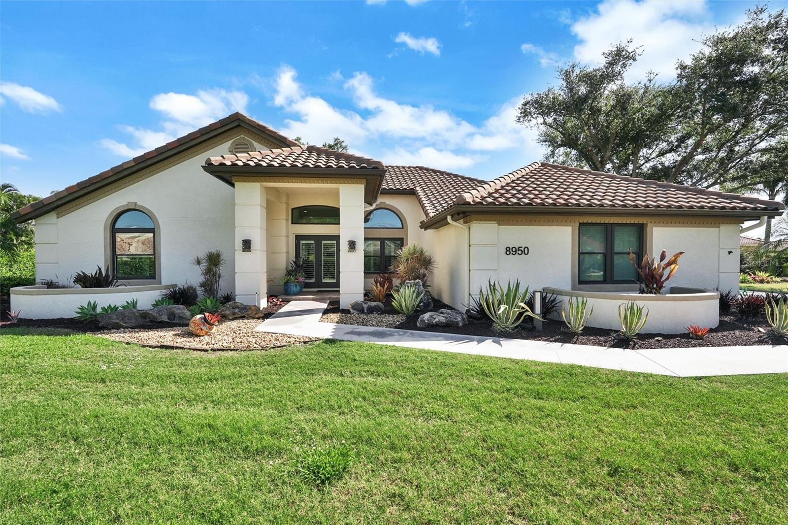 Welcome to your dream home at 8950 Misty Creek Drive in the sought-after Misty Creek subdivision of Sarasota, Florida. This exquisite property offers the perfect blend of luxury, comfort, and security on a sprawling 0.8 acre private lot - one of the largest in the community.
Nestled within a guard-gated community, this completely remodeled home provides peace of mind and exclusivity. No surface has been left untouched in this stunning renovation. As you approach the residence, you'll be greeted by Selby Gardens-inspired landscaping, creating a lush, tropical paradise.
Located in Sarasota, this home offers easy access to world-class beaches, cultural attractions, and fine dining. The Misty Creek community itself boasts a range of amenities, including a par 72 Ted McInnis designed golf course surrounded by nature. Club membership is optional and not required. You can walk to dinner at Misty Creek Country Club or take a short walk, bike ride, or golf cart trip to nearby grocery stores and shopping amenities. Excellent public schools including Pineview School for the Gifted with bus service, or bike to the private Classical Academy.
8950 Misty Creek Drive is more than just a house; it's a lifestyle. Don't miss this opportunity to make this exceptional property your new home.