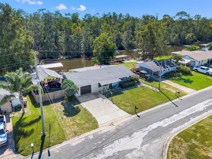 Gorgeously upgraded canal front home with direct access to Little Lake Harris!  This is it!  Finally your chance to own slice of Florida paradise where you can boat, fish, and ski right off your back yard on the Harris chain!  Turn-key and move in ready this block home features 2 bedrooms both with en-suite bathrooms for the most versatile living!  Master has a space for an office or reading nook.  Luxurious wood laminate floors, granite countertops, stainless appliances, and plenty of storage with the oversized one car garage, huge laundry room, and extra living space in the enclosed Florida room.  Open floorplan offers plenty of bright natural lighting for warmth while you enjoy the stunning water views right out the window.  Now is the chance to own your slice of Florida lake living!  Low HOA covers water utility and includes use of clubhouse and community boat ramp.