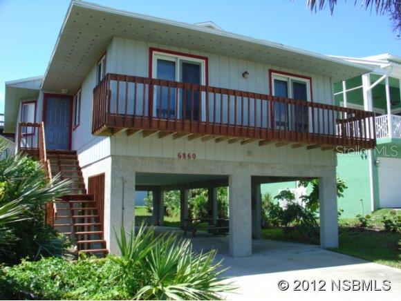 Ocean Peeks from this 3BR/2BA Open floor plan home on stilts providing plenty of off street parking or plenty of room for entertaining. Panoramic views from the Ocean to the Estuary on the widows walk. 1 Block to the ocean, 4 Car Covered Parking, Front & Back Balconies, & Double Sliders on the Front ~ Nice and unique home. Plenty of shade from the trees and shrubbery on this property.. ;Water: City