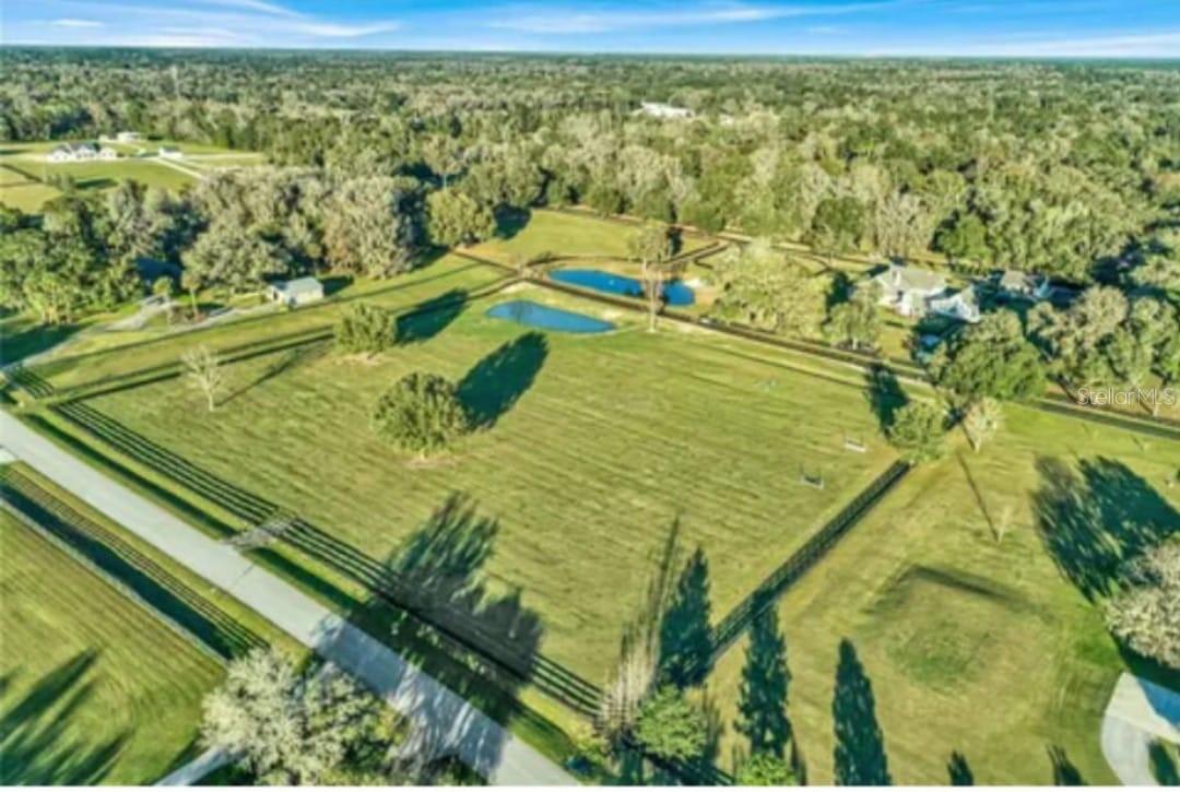 Located in South Ocala, this exceptional 5-acre property offers a rare opportunity to build your dream estate in the prestigious Bridle Run community. This is the last remaining vacant lot, making it a truly unique find.
With a peaceful pond and a serene atmosphere, this parcel is the perfect canvas for your vision. Whether you dream of a sprawling ranch-style residence, a cozy cottage, or a modern architectural masterpiece, the possibilities are endless on this prime piece of Florida real estate. You’ll have plenty of space for outdoor living, gardening, or simply enjoying the Florida sunshine.
For equestrian enthusiasts, this property is horse-friendly, offering ample room for stables, pastures, and your very own equestrian retreat. The community of Bridle Run also features a bridle path around the perimeter, adding to its charm and appeal.
The location is second to none: just minutes from vibrant Downtown Ocala, close to top-rated schools, shopping, dining, and entertainment. You’ll also have convenient access to Florida’s pristine parks, scenic trails, and major highways for easy commuting to nearby cities.
Ocala is world-renowned for its equestrian culture and natural beauty, and this property places you right at the heart of it all.