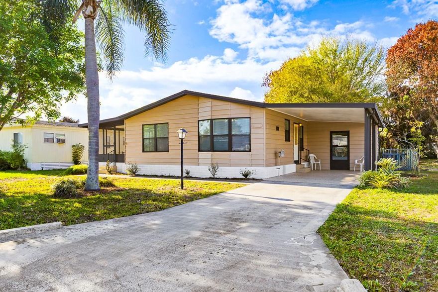 This newly remodeled manufactured home is located in the desirable St Lucie Falls 55+ community, where YOU OWN THE LAND. The 2-bedroom, 2-bath double-wide features ALL NEW architectural shingle roofing, scratch-and water-resistant laminate floors throughout, quartz countertops, fresh kitchen cabinets, updated bathroom vanities, freshly painted interior and exterior throughout, modern ceiling fans and light fixtures, Samsung electric appliances, and numerous hidden upgrades.
Upon entering, you'll immediately appreciate the eat-in galley-style kitchen that seamlessly connects with the living room and dining area. The spacious master bedroom includes an en-suite bathroom. Start your mornings with a cup of coffee on the enclosed screened porch, which leads to a FULLY FENCED YARD perfect for pets and includes several mature fruit trees.
The exterior shed/workshop contains a laundry room with a newer washer and dryer, a large utility sink, and a quartz countertop folding station. St Lucie Falls offers a range of amenities, including two heated pools, two clubhouses, a fitness room, banquet facilities, library, shuffleboard, bocce ball, tennis, pickleball courts, and optional off-site RV/boat/truck parking for an additional fee. The community is conveniently located near I-95 for easy travel south to Miami or north to Orlando, and only 30-minute drive to beautiful SE Florida beaches.  All this with low HOA fees. This home is a must-see!