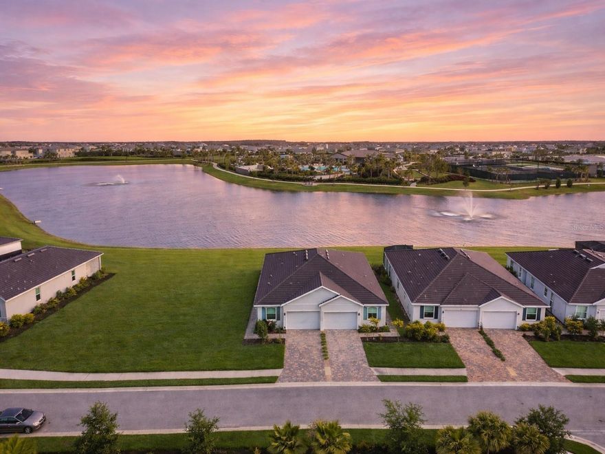 One or more photo(s) has been virtually staged. This is the villa that makes buyers stop scrolling—beautifully maintained, thoughtfully upgraded, and ideally set on one of the most desirable premium waterfront lots in Star Farms. Better than new, this exceptional Siesta home offers the perfect blend of luxury, leisure, and maintenance-free living in the heart of Lakewood Ranch. Perfect living and lifestyle: a rare like-new waterfront villa home near the private clubhouse with a tile roof, long brick paver driveway, and peaceful lake views, 3 bedrooms, 2 baths, a 2-car garage, and an open, light-filled floor plan. The home is both stylish and functional, designed for effortless daily living and easy entertaining. The spacious layout features amazing water views from nearly all rooms, a well-appointed kitchen with stainless steel appliances, a large one-level granite center island, a huge walk-in pantry, split-bedroom privacy, and a flexible third bedroom with French doors that functions beautifully as a guest room, den, or home office. The generously sized primary suite is a peaceful retreat with serene lake views, a high tray ceiling, a walk-in closet, and an en-suite bath with dual sinks and a walk-in shower. Additional highlights for this home include must-have smart home technology features that allow you to control your home from anywhere. Even the fine details are finished, the home is equipped with gutters, a screened-in lanai, new ceiling fans, window coverings, a washer and dryer, and epoxy-finished garage and lanai surfaces, adding to the maintenance-free lifestyle. With all the extras this exceptional villa offers, you can easily save thousands compared to other villas. The award-winning Star Farms community is about far more than square footage. It is about waking up in a home that feels like a retreat and enjoying a community designed to help you live your best life in Florida. This home is exclusive to the desirable Adventure Freedom section, only this small section of residents can enjoy exclusive access to the Private Adventure Retreat Clubhouse and active-adult amenities tailored to wellness, recreation, and connection, including inviting social spaces, pool and spa areas, cabanas, beach-style lounging, pool and card table, racquet sports, bocce, a resistance pool, grilling areas, dog park, and fitness amenities. In addition, homeowners have access to Star Farms’ larger resort campus, including The Resort Club, The Palm Bar, and Cabana Corner, with a fitness center, performance center, coffee shop, bar and restaurant, golf simulator, exercise programming, resort-style pool and spa, and a wide variety of sports and recreational amenities. Adventure Retreat's exclusive lifestyle and activity directors help create a vibrant calendar of daily activities and community events, making it easy to stay active, social, and inspired.  This is the luxury of immediate enjoyment—no waiting on construction timelines, no uncertainty about the lot, and no guessing what the finished resort amenities will feel like. This home offers a standout, amazing water view that will sell quickly, along with immediate access to an established resort lifestyle in one of Lakewood Ranch’s most amenity-rich communities. Close to shopping, dining, golf, world-class beaches, airports, new medical facilities nearby, and everything that makes the area so desirable. Come experience Star Farms! Take the tour of the home and amenities that make this community truly exceptional. Call for your private tour!