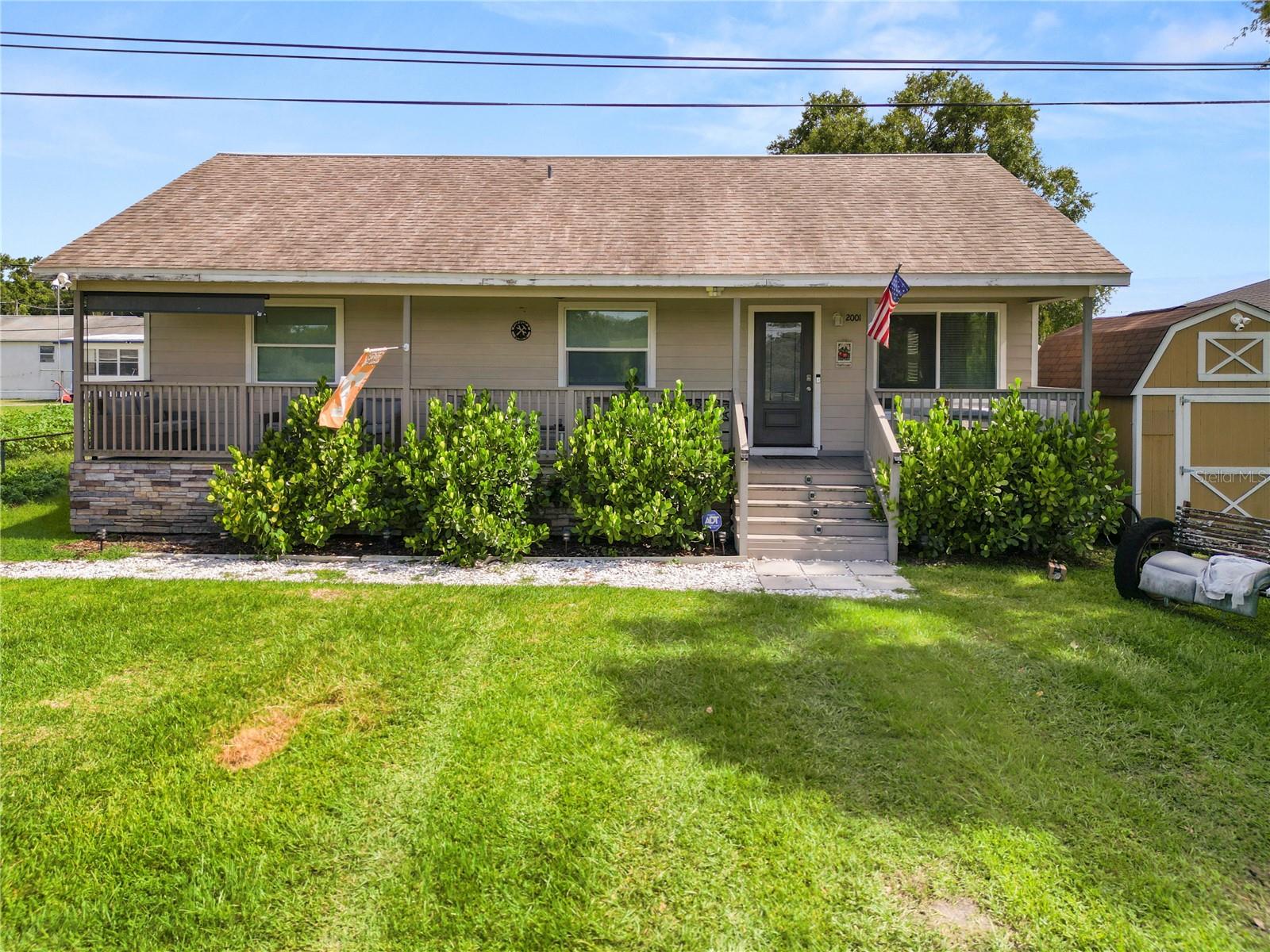 Short Sale. Take a look at this completely remodeled 3 bedroom 2 bathroom home conveniently located in Plant City with easy access to dining, shopping, and schools. Arriving at the home, you’ll love the front porch stretching the entire length of the home, the perfect spot for enjoying your morning coffee or reading a book! Entering the home, you’ll find laminate flooring throughout and an open floor plan. The spacious living room seamlessly flows into the remodeled kitchen featuring stainless steel appliances, granite countertops, and new cabinets. There is a large island as well, great for those quick meals. You’ll find the indoor laundry room behind the barn door just off the kitchen. The primary bedroom is spacious with plenty of natural light, and an en suite with a single sink vanity and tiled stand up shower with a glass door. The remaining bedrooms offer plenty of space and share the main hall bathroom with a single sink vanity and a tub/shower combo with tile surround. Outside, you’ll find a fenced backyard, and plenty of space for BBQ’s with friends. pergola in the back yard for easy relaxing in the evenings. This home has so much to offer, schedule your private showing today!