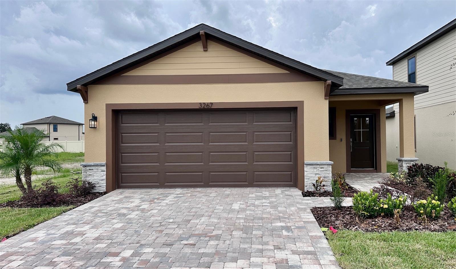 Welcome to The Atlantic, a thoughtfully designed ranch-style, single-story home located in the highly desirable community of Grasslands West. This beautifully appointed 3-bedroom, 2-bathroom residence offers the perfect blend of style, comfort, and functionality — all in a serene, master-planned neighborhood just minutes from everything you need. From the moment you arrive, you'll be impressed by the home's elegant curb appeal, featuring a paver driveway and lead walkway that set the tone for the high-quality finishes found throughout. Step inside to an open, light-filled floor plan designed for both relaxed living and effortless entertaining. At the heart of the home is a modern chef’s kitchen, showcasing granite countertops throughout, ample cabinetry, and a spacious island perfect for meal prep or casual dining. The kitchen flows seamlessly into the dining area and living room, making everyday living and hosting guests a breeze. The private primary suite is your personal retreat, offering a spacious bedroom, a walk-in closet, and a luxurious en-suite bath with granite-topped dual vanities. Two additional bedrooms provide flexibility for family, guests, or a home office — all thoughtfully laid out to ensure comfort and privacy. Step outside to your covered lanai, the perfect spot to unwind, entertain, or enjoy your morning coffee while overlooking your backyard. With smart home features integrated throughout — including keyless entry, programmable thermostat, and smart lighting — you’ll enjoy modern convenience and added peace of mind. Located in Grasslands West, a growing community known for its welcoming atmosphere and convenient access to major highways, shopping, dining, and top-rated schools, this home delivers on every level. Whether you're seeking your first home, a place to grow, or a low-maintenance forever home, The Atlantic is a must-see. Don't miss your chance to own this stunning new construction home in one of the area’s most exciting new communities. Schedule your private tour today and experience the lifestyle you’ve been waiting for!