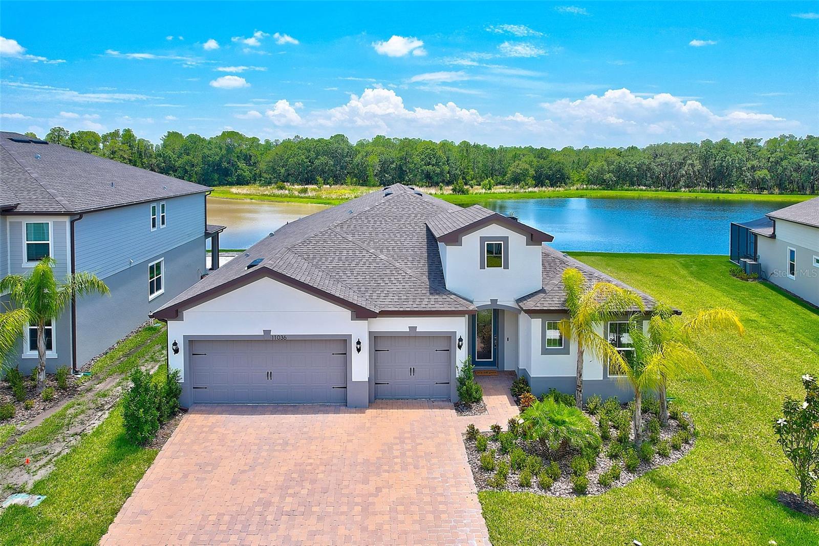 **WELCOME HOME** Tucked away on a premium waterfront lot inside the gated Sundrift community, this three bedroom with an additional bonus room, three and one half bathroom, three car garage home is simply a must see! Curb appeal abounds with a brick driveway and manicured tropical landscaping welcoming you home. As you step inside you’ll be greeted by an abundance of natural light and charmed by the attractive vinyl plank flooring that runs throughout the home. Your tour begins with a large dedicated entry area highlighted by an in-laid glass front door. The home features a three-way split bedroom floor plan with the first located in its own wing off the entry along with a full hall bathroom. Open concept living shines in the expansive great room with the kitchen overlooking the living and dining areas. The kitchen leaps from the pages of the latest design magazine, appointed with many stylish features including granite countertops, a large island with counter seating, 42” cabinetry, stainless steel Kitchen Aid appliances including a built-in oven and microwave along with a separate cooktop, and a walk-in pantry. The great room features a recessed ceiling and large, three panel sliding glass doors that frame picturesque water and nature views. Also located just off the great room through a set of French doors and is an 11' x11' bonus room with a tray detailed ceiling that could be used as an office, craft room, or anything else one can imagine! The owners suite is truly a retreat with a beautiful view of the preserve, a recessed ceiling, and private en suite complete with a large walk-in shower, dual sink vanity, and walk-in closet. The third bedroom and bathroom occupy another wing of the home with the indoor laundry room and access to the garage also located here. The backyard features a large, covered patio with brick pavers with an exterior half bathroom accessible here. The yard presents a wonderful amount of green space with potential for a pool. Every day can feel like a vacation with the community offering world class amenities including a clubhouse, resort style pool, splash pad, playgrounds, tennis courts, miles of trails, and more! Situated in the top rated Pride Elementary, Benito Middle, and Wharton High school district. Wonderful location with countless shopping and dining options located nearby along with easy access to USF and Moffitt. Put it all together and you’ll see why this wonderful home should jump to the top of your list!