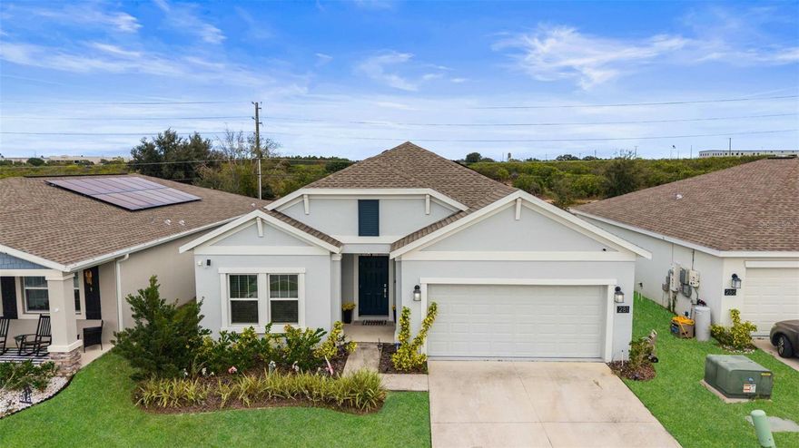 Welcome to this beautifully maintained 2023-built single-story home located in the desirable Magnolia Park community of Haines City. With 4 bedrooms, 2 bathrooms, and nearly 1,850 square feet of thoughtfully designed living space, this home stands out from standard cookie-cutter new construction—offering custom upgrades, elevated finishes, and exceptional value at a lower price point.

Step inside to an open-concept layout filled with natural light, where the kitchen seamlessly flows into the living and dining areas—ideal for entertaining and everyday comfort. The kitchen showcases solid wood cabinetry, solid-surface countertops, stainless steel appliances, a walk-in pantry, and an oversized island with seating, all enhanced by designer lighting and tasteful accents that elevate the space well beyond builder-grade finishes.

The primary suite offers a relaxing retreat, complete with a spacious walk-in closet and a stylish en-suite bathroom featuring dual sinks and modern finishes. Three additional bedrooms provide flexibility for guests, home offices, or multi-generational living. Throughout the home, upgraded touches such as tile flooring in main living areas, plush carpeting in bedrooms, and smart home features create a polished and comfortable living experience.

Outside, enjoy Florida living on the screened patio overlooking the landscaped backyard, perfect for morning coffee or evening gatherings. This home also includes leased solar panels designed to significantly reduce monthly utility costs, offering energy efficiency and long-term savings without the premium price tag. Additional highlights include a two-car garage, irrigation system, and Flood Zone X designation for added peace of mind.

If you’re looking for a nearly new home with upgrades already done—without paying new construction pricing—this is the one. Schedule your private showing today and experience the difference firsthand.