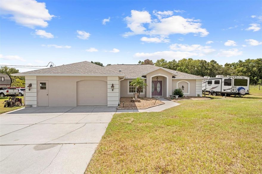 Bring the horses and enjoy country living on 2.6 acres in Brooksville! This 3-bedroom, 2-bath block home sits at the end of a private road and is zoned Agricultural—perfect for animals, hobby farming, or simply enjoying space and privacy.

Inside, you’ll find high ceilings, laminate flooring in the main living areas, tile at the entry, and linoleum in the bedrooms and baths for easy maintenance. The master suite offers dual sinks, a walk-in shower, and two walk-in closets, while the guest bath features a tub/shower combo. The home also includes a separate dining room, an eat-in kitchen space, and the washer and dryer stay.

The property has been well cared for with a new roof in 2024, HVAC replaced in 2018, a well pump replaced within the last few years, and a septic drain field that has been replaced and doubled. The garage is fully insulated, with one side designed for parking and the other side set up as a workshop. The back lanai ceiling is insulated as well, and the shed is outfitted with heat and AC, electric, and water. Additional features include an above-ground pool, a barn with three stalls and a tack room, a full RV hookup with water, septic, and electric, and a water diversion system at the driveway. This property is not in a flood zone.

Ask about the assumable VA loan for added affordability. This home is set up for both comfort and functionality and is ready for its next owner to enjoy the rural lifestyle.