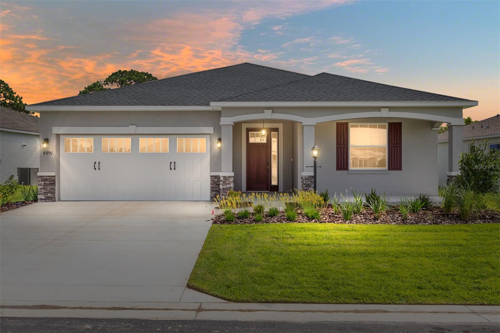 Welcome to the brand-new construction Ginger model, offering the perfect blend of modern design and comfort in Weybourne Landing at On Top of the World. This stunning home features 2 bedrooms, 2 bathrooms, a versatile flex room, and a spacious 2-car garage. Step inside to discover beautiful wood like tile flooring throughout the main living areas and bathrooms, while carpeting adds warmth to the bedrooms and flex space. The gourmet kitchen is a chef’s dream, showcasing staggered two-toned cabinets with crown molding, a generously sized island, quartz countertops, a pantry, and stainless-steel appliances. The open concept living area is enhanced by a stylish tray ceiling, and the private backyard with no rear neighbors offers peace and serenity. Sliding glass doors open to a screened lanai, perfect for unwinding and enjoying the fresh air. The spacious primary suite features large windows with serene backyard views, a walk-in closet, tray ceiling, and an elegant en suite bath. The en suite includes a double vanity with quartz counters, a zero-entry walk-in tiled shower with a bench, and a linen closet for added convenience. Designed with guests in mind, the second bedroom and bathroom provide a comfortable retreat for family and friends. Located in Ocala’s premier gated 55+ community, On Top of the World offers a wealth of amenities, including golf courses, pools, fitness center, trails, and golf cart access to nearby shopping centers. Call today to schedule your showing!