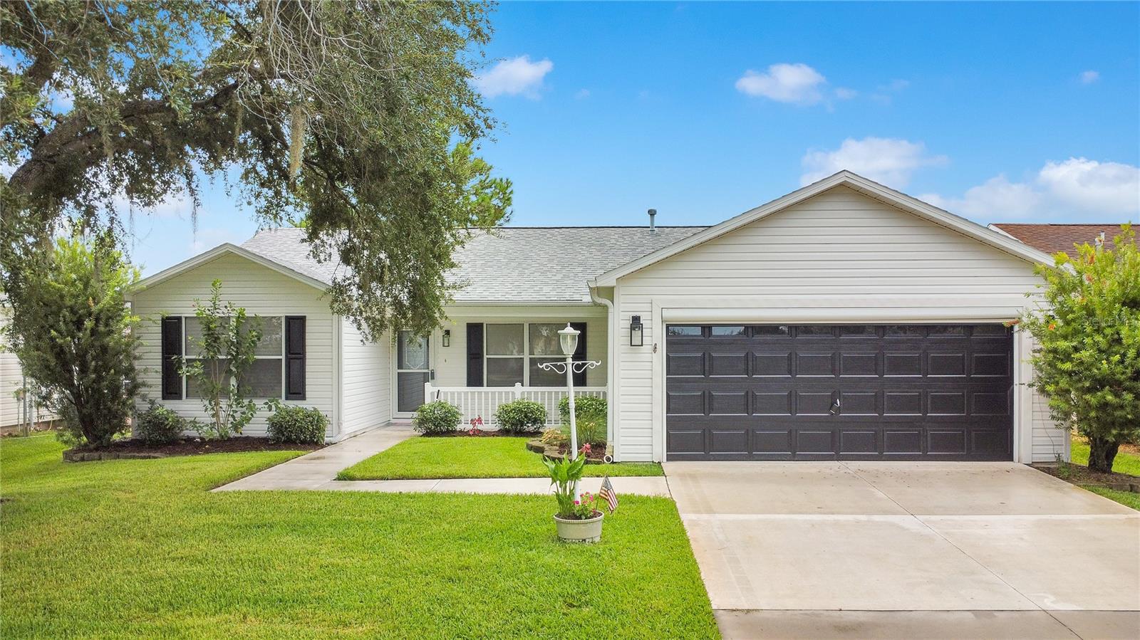 Welcome to your new pool home in the Villages! Do not miss this modern, turn-key and updated 3 bedroom, 2 bathroom, split floor plan home in the Village of Ashland. This property has been newly renovated for modern comfort and style and comes with a one-year Home Warranty paid for by the sellers! The interior features brand new Luxury Vinyl Flooring throughout the living room, kitchen, bathrooms, hall and laundry room. The kitchen has been completely remodeled and shines with quartz countertops, a marble tile backsplash, updated cabinets and stainless steel appliances. Both bathrooms have marble tile showers with frameless shower doors, custom niches, new tile flooring and updated vanities. Custom marble windowsills add an elegant touch throughout the home, complimented by new recessed lighting and custom molding in the main living area. There are beautiful steel glass French patio doors that lead to the lanai and pool area. The large primary suite offers walk in closets, while both bathrooms and the hallway provide ample linen storage. The back bedroom offers a Murphy bed. All furnishing in the house are included. The outside has been freshly painted with updated outdoor lighting and a screened in patio; perfect for entertainment and relaxation. The home is equipped with a Tesla charging station for convenient, at-home EV charging. You will appreciate the thoughtful upgrades throughout this home, combined with modern design, everyday conveniences, and the vibrant lifestyle of The Villages.
