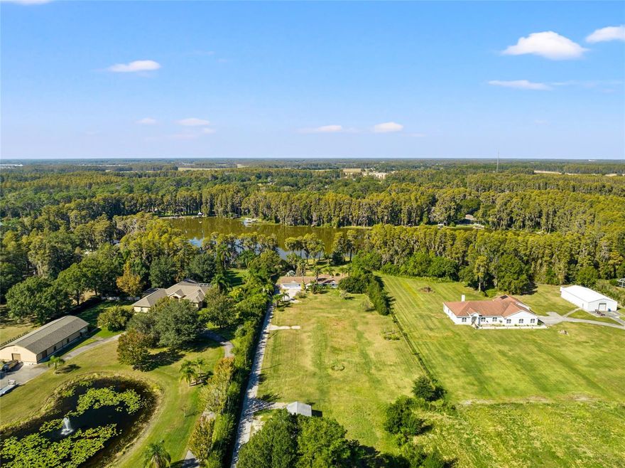 Just imagine this... Lakefront Pool Home on over 3 Acres in Land O Lakes!  Pulling down your long driveway, you will see how private your property is, all tucked away from the hustle and bustle.  Come on into this lovely 4BR/2Bath Ranch Style Home featuring a nice open floor plan with newer wood look tile throughout the main living areas and foyer area! Nicely updated kitchen with granite countertops, and new appliances including a double oven.  Off the Kitchen and Foyer area you will find an extra-large Dining area with a picturesque view of the lake. The open living room is very spacious and features a wood burning fireplace to sit and enjoy the cold evenings while watching your favorite TV Show or Movie.  Just a few steps away, you will find your 3 guest BR and Bath which are all very nice size rooms.  On the opposite side of the home is where you will find your Master Suite which offers a sizeable walk-in closet and your Master Bath with dual vanity sinks, garden tub and separate shower.  Step out through your double doors from your Living Room into your enclosed Florida Room which could be used as an Office, Playroom, extra room to entertain your guest or anything you wish!  Stepping outside, you will notice a nice size sitting area with brick pavers which also leads you to your screened enclosed heated pool (redone in 2020) surrounded by brick pavers!  Walk down to the lake where you can sit and enjoy your morning coffee or evening drink while enjoying the view and listening to the sounds of nature.  Please don't forget to bring all your outdoor toys to this lovely Home and Property as you have plenty of room to store them!  Close to Shopping, Library, Sports Complex, Restaurants, Schools and much more! Don’t wait on this lovely Home as it won’t last long!