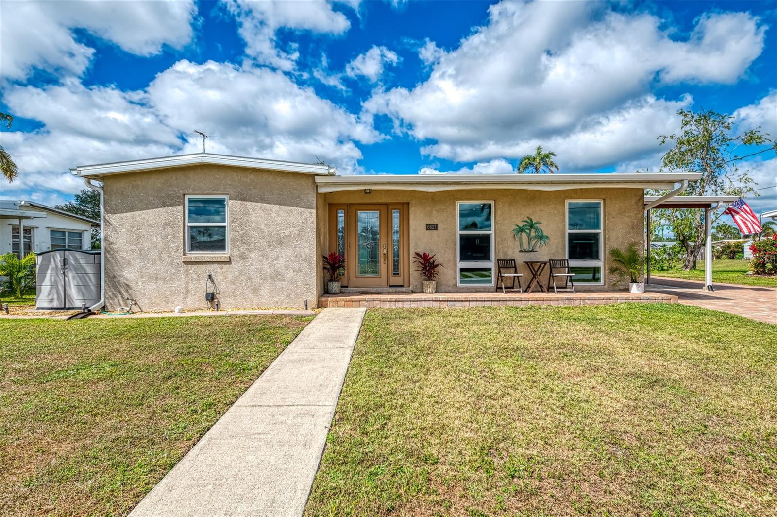 What a little slice of Paradise nestled in this peaceful neighborhood. This charming 2- bedroom, 1- bath POOL HOME, offering the perfect blend of style & functionality. This property has been meticulously maintained with numerous upgrades inside & out including GAS cooking & heat with public utilities complete with a Water Softener. All windows (new sills) and doors are hurricane proof with a NEW roof & gutters-2024, AC 2017, piping under slab has a new liner 2021, outside landscaping with lighting has been added to also enhance the Pavers throughout extending to the pool area. Carport has a storage room along with a 16x10 Double loft shed in the back with electric for ample storage or a workplace. Electric panel has been updated to 200 AMP. Upon entering the house, you will notice the open floor plan with panoramic views of the water. NEW vinyl planking flooring giving it a clean & contemporary feel consistent throughout, freshly painted, recessed lighting & 4 ceiling fans. Kitchen has remodeled cabinets & counters with a large breakfast bar for four and new appliances including a GAS stove with a griddle. Two bedrooms are adjacent to the family room with a renovated full bath. Ideal for those who enjoy the outdoors, let's step outside to the screened covered Lania area with Sunshades, whether it be to enjoy the refreshing Saltwater Pool, Hot tub or to Grilling your favorite meals, what a great relaxing or entertaining area with water views. Enjoy the extended Paver Patio off the pool to retreat to one of 3 outside entertainment areas. Take a small stroll down to your fire pit for ambiance & toasting marshmallows or stroll over to your treated wood Dock 8x20 with electric & a Cement Seawall. For water enthusiasts, imagine docking your boat right at your doorstep or indulging in serene sunsets views and fishing right in your backyard. This property is within 14 miles to the beach. Enjoy the Award Winning Wellen Park for shopping, Walks, Costco's, restaurant's, Cool Today Park Stadium & Fresh Farmers market WELCOME HOME!