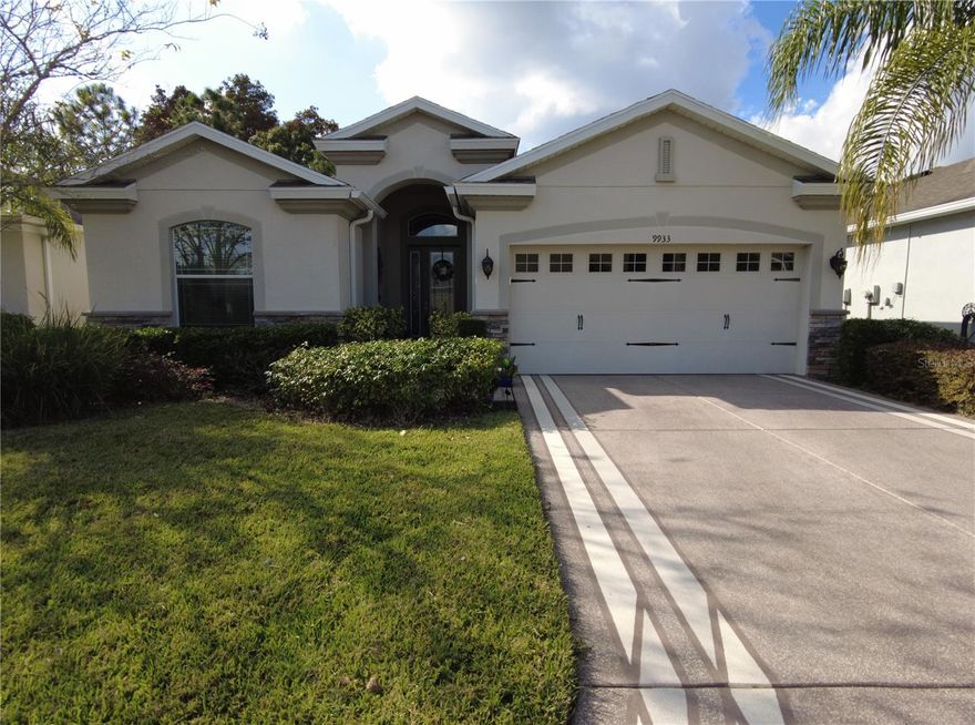 Enjoy breathtaking waterfront and conservation views from this premium lot in one of the most peaceful settings in the community! Relax on the screened paver lanai overlooking a large pond where you can watch turtles, otters, deer, and sandhill cranes in their natural habitat. This immaculate one owner K. Hovnanian home offers an open-concept layout with elegant archways, eyebrow windows, large ceramic tile floors, LED recessed lighting, and a welcoming stack-stone exterior with a custom etched-glass front door. The deluxe kitchen features granite countertops, a large island/breakfast bar, a dual-door refrigerator, and a striking backsplash, all opening to the great room and dinette with serene water views from most rooms. The owner’s suite includes a tray ceiling, spacious walk-in closet, and a stunning walk-in shower with a decorative glass listels band and raised-height commode, while the split-bedroom design ensures guest privacy. Additional highlights include energy-efficient double-pane windows, radiant barrier insulation, a 2.5-ton A/C system, ceiling fans and cable wiring in every room, a coded garage keypad, and an interior laundry room with extra storage. Located in a resort-style gated 55+ community with golf, tennis, pickleball, two pools, a fitness center, restaurant, and numerous activities and excursions. Perfectly situated just minutes from I-75, Tampa Premium Outlets, The Grove, and Wiregrass Mall, this home offers the perfect blend of tranquility, quality, and convenience. The property is also being sold fully furnished. Schedule you showing today!