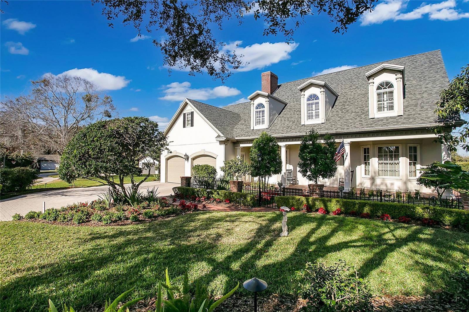 Experience the epitome of lakeside luxury in this stunning residence, nestled on a half acre of pristine lakefront property. Built in 2004, this dreamy 5 bedroom, 4 full bathroom, 2 half-bath home greets you with curb with it’s classic architecture, dormer windows, and meticulous landscaping leading to a graceful entryway with an inviting front porch framed by stately columns. Step inside to be welcomed by rich hardwood flooring, a gorgeous grand staircase, French doors adorned by transom windows, wainscoting, and high ceilings creating a sense of grandeur. Heading through the formal entertainment spaces of the living room and dining room complete with a wet bar creating the perfect setting for intimate dinners or grand celebrations. The heart of the home is the gourmet kitchen, featuring top-of-the-line stainless steel appliances, custom cabinetry, an expansive center island, a huge walk in pantry, and cozy breakfast nook. The design flows effortlessly to the adjoining Florida room with arched windows and exposed bricked overlooking the lake. The first floor primary bedroom provides relaxing water views, direct access to the screened in lanai, and dual walk in closets complete with a spa-like ensuite. Head upstairs to discover a second primary bedroom and adjoining primary ensuite that is sure to impress with its stained glass windows, oversized shower, separate dual sinks, and claw foot tub. Also on this floor you’ll find a bonus room, two storage rooms, and three guest bedrooms each with their own individual style. In the bathrooms, elegance is articulated with classic fixtures and clean lines resonating with timeless sophistication. Outdoors, the property's grandeur continues, undoubtedly the star of the show with its sprawling patio and backyard oasis offering breathtaking lake vistas, making it the perfect backdrop for a peaceful escape or hosting unforgettable events. Mature Oak trees frame your views of the lake and provide dappled shade over the brick pathways that meander down to a private dock on Lake Gatlin. This home’s centralized location is just as impressive. Just a stone’s throw away from some of Orlando’s best foodie hotspots, and entertainment with easy access to the highway for traveling or commuting. Zoned for Pershing K - 8 and Boone High School (Go Braves!) and just minutes from Cornerstone Charter Academy (K-12). This residence is more than just a home; it's a lifestyle offering unparalleled sophistication, comfort, and privacy. Make this lakefront jewel your own and schedule your private showing today!
<div style="padding:56.25% 0 0 0;position:relative;"><iframe src="https://my.matterport.com/show/?m=qhdKoYEX7m5&mls=1" frameborder="0" allow="autoplay; fullscreen" allowfullscreen style="position:absolute;top:0;left:0;width:100%;height:100%;"></iframe></div> Bedroom Closet Type: Walk-in Closet (Primary Bedroom).