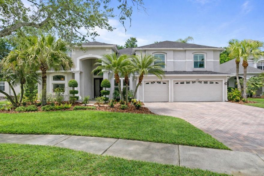 Extensively remodeled with approximately $345,000 in upgrades, a newer roof (2022), and a pre-inspection already completed with key systems, including electrical upgraded. This exceptional home offers a rare combination of luxury, functionality, and true move-in-ready confidence within the gated Ashington enclave of Tampa Palms.

This 4-bedroom, 3-bath residence with loft and 3-car garage spans over 3,300 square feet and features a highly desirable layout, including a first-floor primary suite and a private guest suite.
A dramatic entry through double beveled glass doors opens to formal living spaces with two-story coffered ceilings, elegant tile flooring, crown molding, upgraded baseboards, and contemporary LED lighting throughout.

The fully remodeled chef’s kitchen is both stylish and functional, featuring quartz countertops, custom cabinetry, KitchenAid appliances, a 6-burner gas range with vented hood, designer backsplash, and a separate dinette. The kitchen flows seamlessly into a spacious family room with soaring ceilings, expansive windows, and triple-pane sliding glass doors (2019), creating a bright and open living environment.
The first-floor primary suite offers a private retreat with custom closets, direct lanai access, and newly installed ceramic flooring (2025). The primary bathroom, renovated in 2021 ($86K), includes quartz countertops, designer finishes, a freestanding soaking tub, and a glass-enclosed shower.

A secondary bedroom on the main level features its own dedicated full bathroom and direct access to the lanai, ideal for guests, in-laws, or flexible living arrangements. Upstairs, a large loft overlooks the main living area and is complemented by two additional bedrooms and an updated bathroom.

Outdoor living is a standout feature, centered around an expansive approximately 2,400 square foot screened lanai designed for both entertaining and relaxation. The space includes an updated pool with sun shelf and water features ($75K), travertine decking (2019), a new wood ceiling (2024), outdoor kitchen with gas grill and granite bar, hot tub, gas fire pit, water feature, putting green, and a custom tiki hut.

Additional upgrades include triple-pane windows and sliders (2019), upgraded main floor HVAC with remaining warranty, water heater (2020), RainSoft water filtration system (2019), new vinyl fence (2022), new exterior paint (2026), super gutter with additional drainage system for the lanai, and a newly refreshed driveway and entryway.

Located in the heart of New Tampa, just minutes from top-rated schools, I-75, USF, Moffitt Cancer Center, AdventHealth, parks, and miles of trails, and within 5–10 minutes of Hunters Green and Tampa Palms Country Club.

This property offers a rare opportunity to own a fully upgraded home with significant capital improvements already completed, combining luxury living with long-term value and reduced maintenance concerns.