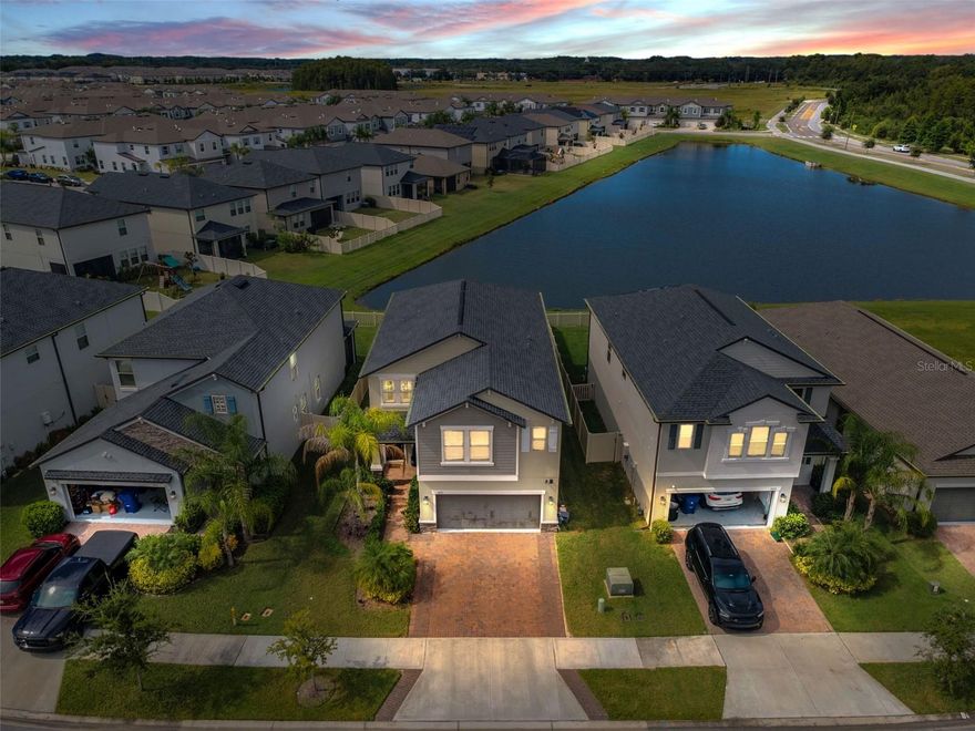 Exquisite residence in Bryant Square. Perfectly situated on a premium homesite with water views. This beautifully remodeled home in sought after Bryant Square offers elevated design, modern luxury, and serene lake views. The newly reimagined interior showcases a designer aesthetic throughout, featuring a custom wall treatment in the formal dining room and a dramatic floor-to-ceiling marble fireplace that serves as a stunning focal point. The chef inspired kitchen is a true showpiece with expansive shaker cabinetry, sleek quartz countertops, a built in dining table, and top of the line stainless steel appliances, including a Cosmo Commercial 48" 6 burner gas range with double ovens-ideal for entertaining and culinary pursuits. The elegant primary suite offers a serene retreat, while the spacious bonus room features built-in bookshelves, perfect for a study, media space, or home office. Custom draperies as well as the stunning West Elm and Restoration Hardware lighting convey. Enjoy access to resort-style community amenities, including a sparkling pool and recreation areas, ideally located near award-winning schools, premium shopping, fine dining, and hospitals, this exceptional home blend luxury living with everyday convenience.