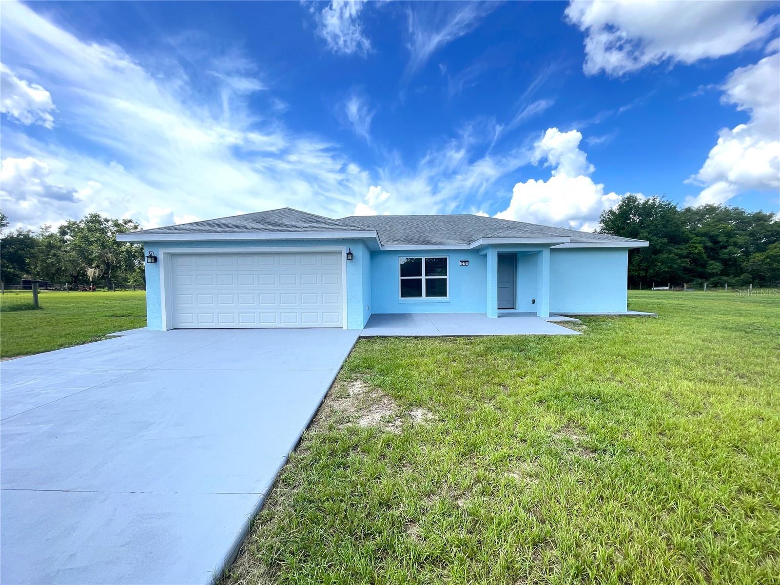 Tucked away on 1.64 acres of pristine, open land in beautiful Ocklawaha—just minutes from the heart of Ocala, the charm of The Villages, and the sparkling shores of Lake Weir—this remarkable property isn’t just a home... it’s a lifestyle waiting to be lived. Built in 2020, this nearly new home offers peace of mind and modern comforts wrapped in a serene, rural setting. Step outside and you’ll quickly realize: this isn’t just any backyard. It’s a private world of possibilities—fenced and spacious enough to raise poultry, tend livestock, grow fresh crops, or even pursue your equestrian passions. Whether you're dreaming of a small hobby farm or simply long for room to breathe and stretch, this land delivers. There’s a certain magic here—a stillness that whispers, “You’re home.” And yet, while you’re surrounded by nature and freedom, you're never far from what matters. Enjoy quick access to local shopping, top-rated schools, and restaurants—and spend your weekends swimming, boating, or relaxing at Lake Weir, just five minutes away. Whether you're a first-time homebuyer seeking value and long-term growth, a seasoned investor looking for a secure asset in a thriving region, or a family wanting more space and more soul, this property is a rare opportunity that checks every box.
Modern construction. Acreage. Privacy. Location. Freedom.
These don’t often come together. But here, they do. Don’t just buy a house—own a future filled with peace, purpose, and pride. Schedule you showing today!