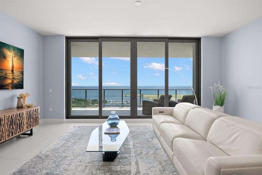 AN UNBEATABLE VIEW OF TAMPA BAY is surely the first thing you'll notice from inside this 24th floor waterview condo! Looking strait out at Tampa Bay and Downtown St. Petes marinas from your living room sofa, bedroom, and office/ secondary bedroom! Step out onto the expansive covered balcony for a prismic sunrise in the morning and a relaxing sea breeze during a coffee and a good read. In the evening throughout the year this balcony will provide you with a stellar view of Downtown St. Pete events such as the St. Pete Grand Prix, TB Rowdies games at Al Lang, concerts on the waterfront parks, or planes taking landing and taking off from Albert Whitted Airport. This beautiful building is right in the middle of the best parts of St. Pete. With sound and hurricane rated windows and sliding glass doors, this central location still comforts you with your own peace and quiet inside. Your expansive, open concept great room leaves not to be desired with abundant space for your living, dining, and kitchen necessities, and luxuries! The kitchen boasts quartz countertops with a waterfall island to delight you as soon as you walk in your front door, top of the line custom cabinetry, and impressive JennAir built in appliances. To one corner of the kitchen is an enclosed den, perfect for an office, movie theater room, or extra bedroom/ guest space as it has a full bathroom accompanying it to the east. On the other corner of the kitchen there is a large laundry and storage room for all regular necessities and additional cabinet space for extended pantry storage. Off the great room on either side are bedrooms with en-suite bathrooms. The south bedroom being your spacious master suite with two large, built out, walk in closets on the way your huge primary bathroom. Boasting a large step in shower with built in bench and dual shower heads, a water closet with electric bidet, which is enclosed with a frosted glass door, and big, beautiful vanity with double sinks. Through the north exit of the great room is the secondary bedroom, also with closet space and attached en-suite bath. Floor to ceiling windows and doors on every east wall amplify the view while the tile floors keep every room feeling bright and spacious. Motorized blackout window treatments in the bedrooms keep the daylight out for those mornings you want to sleep in.
Saltaire is a newer building itself, having been completed in 2024 with top of the line finishings and appointments throughout all provided amenities. The 7th floor being the amenities floor has a HUGE stone and tile resort style deck encompassing a large saltwater pool with built in sunning deck, jacuzzi, lounge style pergola cabanas, and an impressive amount of lounge seating and several built in gas grilling areas,  one of which being a full outdoor kitchen and bar. Lastly several fireplaces and extensive foliage is placed throughout this outdoor oasis in extravagant style giving you and your guests that inviting and tropical feel. On the back is an outside dog park with grooming station. Inside on the 7th floor are several sitting and working areas from the coffee bar with cafe seating to a huge entertaining room with a kitchen behind closed door to keep the messy parts hidden. On the north side of the 7th floor is a fully equipped gym to serve all your fitness and wellness needs. This particular unit comes with a private storage locker as well as 2 parking spots, which are not alotted to all residences.