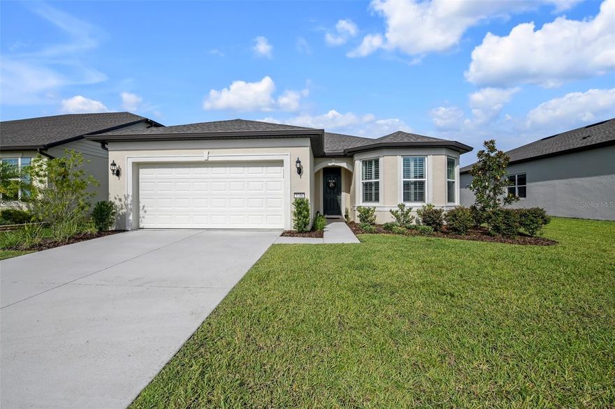 This beautiful newer (2021) Mystique, located in the active 55+ community of Stone Creek by DelWebb, with 2 bedrooms, 2 baths, additional Flex Room / Den, neutral color palette, plantation shutters throughout, luxury vinyl plank and tile flooring, and numerous additional Builder upgrades is move-in ready!  The valuable extended garage boasts a generous alcove area perfect for golf cart parking, workshop, home gym, or extra storage.  The upgraded kitchen package with quartz countertops, tile backsplash, KitchenAid stainless steel appliances, level 3 cabinets with soft-close hinges and drawers, pull out shelves, dual trash bins, corner Lazy Susan, and upgraded faucet on large center island.  The spacious adjoining Family Room and Dining area are light and bright with multiple windows and sliding glass doors to the covered screened Lanai.  The sought after Guest Bedroom provides additional square footage and light with the desirable bay window feature.  The Guest Bath has upgraded fixtures, tiled tub surround with niche, and a single vanity with quartz countertop. The expansive indoor Laundry Room is finished with cabinets, utility sink, shelving, Corian countertop, and a large HVAC/Utility closet with additional storage space.  A Flex Room with double doors is an added bonus and perfect for a home office, den, gym, game room, or hosting additional overnight guests.  The Owners Bedroom provides an ample retreat with en-suite Owners Bath containing a luxurious tiled walk-in shower with built-in bench and niche, dual sinks in a wide quartz topped vanity, spacious walk-in closet, a private water closet, and a convenient linen closet.  Stone Creek is a very active community and has many amenities to enjoy, including a main clubhouse with library, cafe, meeting rooms, ballroom with stage, catering kitchen, etc.  A new amenity building, currently under construction and scheduled to open soon, will provide additional leisure space with billiards, game tables, a golf simulator, an outdoor amphitheater, relaxing patios and outdoor game areas.  The beautiful community outdoor pool and spa complex is directly behind the Elan Spa building, which houses a full fitness center, indoor pool, indoor spa, sauna, steam room, locker rooms, and fitness classes.  Adjacent to Elan Spa there are also 5 Tennis courts, 16 Pickleball courts, 8 Bocce Ball courts, 6 Horseshoe pits, a Basketball court, a fenced raised garden plot area, a Softball field, a Dog Park, a pier with screened gazebo, and a covered Pavilion with picnic tables and restrooms.  There are miles of multi-use paved paths for golf cart, bicycle and pedestrian use throughout the community. The Stone Creek Golf Course winds through the development with a Pro Shop, Driving Range, Putting Green, Bar & Grille, and an outdoor Patio area available for the enjoyment of Members, Residents, and the Public at an additional cost.  Stone Creek is in proximity to the new Florida Aquatic Swimming and Training complex (FAST), The World Equestrian Center (WEC), Medical, Shopping, Dining, Entertainment, Golf, and I75.