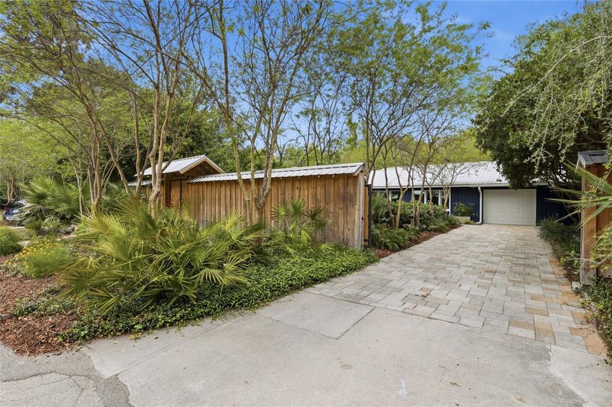 Discover your own private sanctuary in the heart of Gainesville. This thoughtfully designed 4-bedroom, 2-bath home feels like a world apart, yet is just minutes from UF, The Swamp, and the hospitals. From the moment you walk in, sight lines from front to back create a seamless flow, and with fences enclosing the front and back yards, you can enjoy total privacy, so much so, the home doesn’t even need blinds. Every corner of this home connects to nature: a custom, self-sustaining water garden, curated outdoor lighting, and lush landscaping make indoor/outdoor living effortless. A detached building adds flexibility for a home office, studio, or quiet retreat. Here, you can truly be yourself, relax, entertain, and live in a space where neighbors are out of sight, and the outdoors feels like your own park.