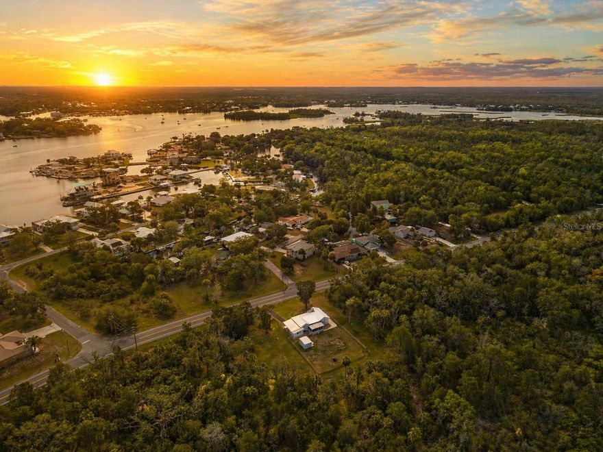 This beautifully updated Ranch-style home offers four bedrooms, two bathrooms, and 1,350 square feet of living space on a spacious lot in Crystal River. Ideally located less than 10 minutes from the Gulf of Mexico, downtown, and the world-famous springs, this single-story property is designed for comfort and convenience with a functional floor plan that flows seamlessly from room to room.The home features a bright living room at the entry, a dining area, and a large kitchen equipped with stainless steel appliances, wood cabinetry, and modern countertops, perfect for both everyday use and entertaining. At the center of the home, the family room provides an inviting gathering space with direct access to the screened porch. The primary bedroom includes its own bath, while two additional bedrooms and a second full bath provide flexibility for family, guests, or office use. A dedicated laundry area adds convenience. Wood-look tile flooring runs throughout, combining durability with style.Outside, the screened porch and patio create the perfect setting for outdoor enjoyment. A covered carport, and a storage shed at the rear of the property complete the home. The home features a brand-new AC system with an added attic fan to improve efficiency and help lower utility costs. The AC includes a transferable warranty for peace of mind. A brand-new water heater has also been installed, and the property comes with a transferable Orkin pest control plan with three years remaining. The septic system, installed in 2020, was serviced, pumped, and certified in June, ensuring everything is in excellent working order. The property is bordered on both sides and at the rear by state-owned land that will not be developed, offering privacy and a natural backdrop. With its close proximity to boating, fishing, kayaking, waterfront dining, and all the natural beauty the Nature Coast has to offer, this home presents an excellent opportunity for a primary residence, vacation retreat, or investment property.