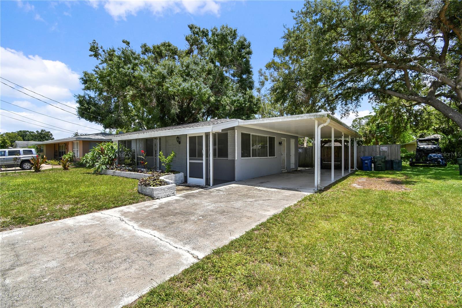 Perfect location. Perfect price and ready for your special touches. 2 bedroom, 1 bath, with bonus room and carport. House is in great condition. Bathroom was updated with new tile, vanity, shower, and toilet. Terrazo floors. Enormous yard that is fenced in with NO HOA or Deed Restrictions. No flood zone. Solid block home, quaint front porch, separate laundry/utility room, newer windows. Great location tucked off Bee Ridge. Short drive to interstate, Siesta Key and downtown Sarasota. Roof is 20 yrs. Ac and water heater newer.