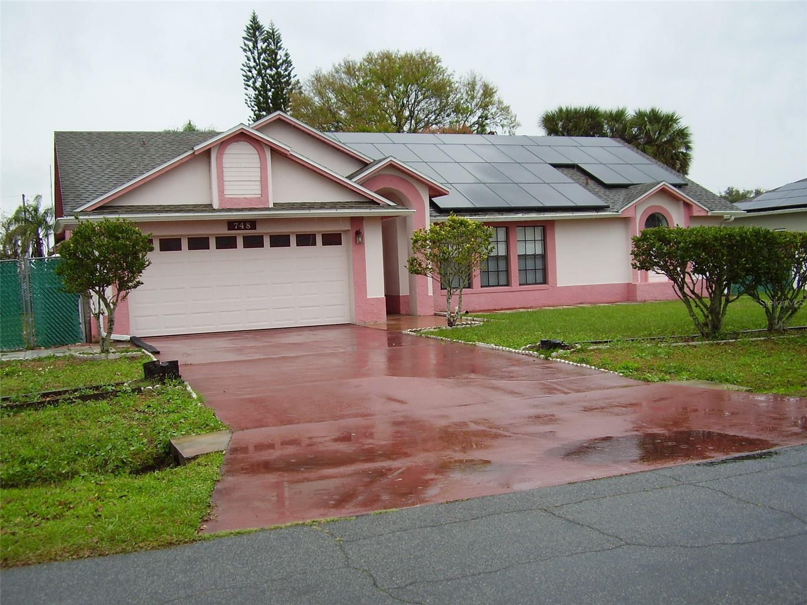 House is located in the Polk County side of Poinciana. It is 3 bedrooms, 2 full bathrooms, separate living room, separate dining room, family room and a beautiful, tiled Florida room of 10.5 x 28 with central air conditioning, 2-car garage. Tiled throughout the house. Property is all fenced. Appliances include refrigerator, electric range, microwave, dishwasher, washer & dryer. House has solar panels paid by the owner. Shed house in the rear.