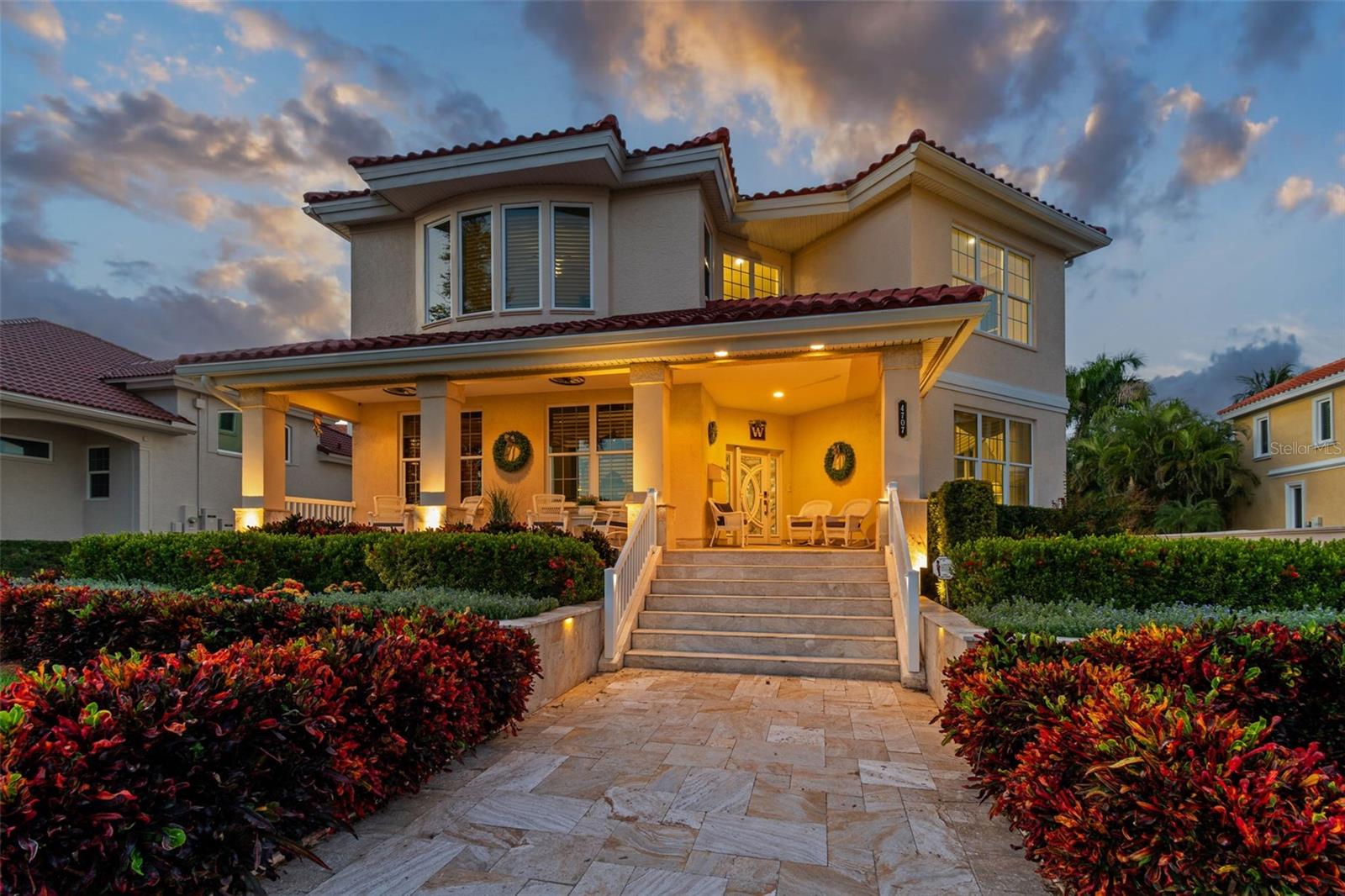 Experience Luxury Waterfront Living in St. Petersburg at 4707 Skimmer Way — a meticulously maintained and fully upgraded 4,950 sq. ft. residence in one of the area’s most desirable gated communities. This move-in ready coastal home combines modern efficiency, timeless elegance, and peace of mind with every major upgrade complete. Interior features include plantation shutters throughout, an expansive open-concept layout, two master suites with spa-style bathrooms, gas fireplaces, a gas tankless water heater (2022), and a detached garage apartment with full kitchen, bathroom, and new A/C (2023) — perfect for guests, in-laws, or rental income. Major improvements include a new tile roof (June 2025), top-of-the-line Trane A/C system (Oct 2023) with 10-year warranty, all-new ductwork (2025), spray foam insulation (2024), impact windows (2017), and a whole-home Kubota diesel generator with refreshed 180-gallon tank (2025) capable of powering the home for 2–3 weeks. Outdoor living is unmatched with a resurfaced PebbleTec pool and upgraded pool deck (2022), travertine walkways, driveway, and porches (2019), professional landscaping with custom lighting, a spacious front porch, and new LED exterior lighting and underground downspout system (2025). The extended 5-ft garage (2022) features a hurricane-rated door, ample storage, and a dedicated workshop/storage room, along with a water softener system for added comfort. Located in a premier gated waterfront community, HOA dues of $418/month include Spectrum cable and internet plus front and side yard maintenance. Just minutes from downtown St. Petersburg, world-class beaches, marinas, dining, and entertainment — this is waterfront luxury living at its finest.
