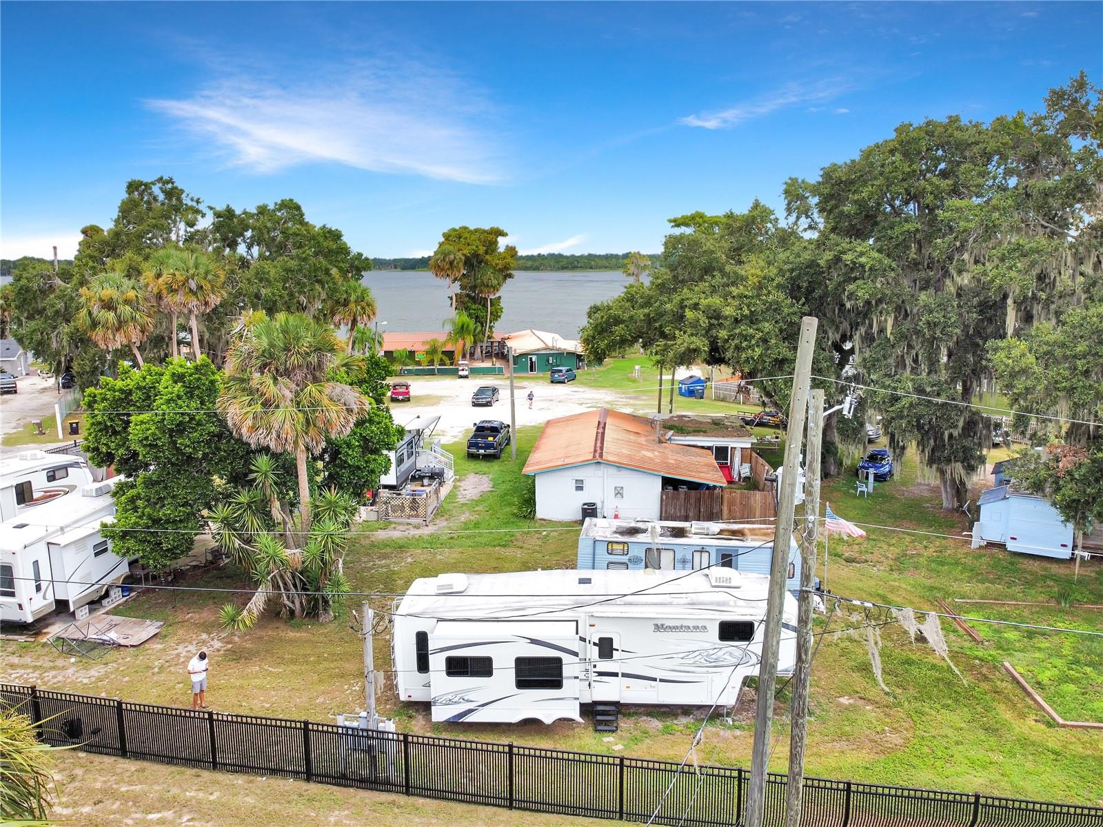 This 2010 Keystone Montana RV is available for rent on a 4,000 sq ft lot within a larger 1.93 acre property. From the RV you can enjoy lake views and it’s just a short walk to the water where you’ll have access to a shared dock, perfect for fishing or relaxing by the shore. The RV offers a one bedroom, one bath layout with a full kitchen, comfortable living area, and an electric fireplace. Community amenities include a lakeside bar and open space to take in the beautiful sunrises and sunsets over the lake. This rental is limited to one occupant and offers a unique opportunity to enjoy peaceful lakeside living while being close to Haines City conveniences. Electricity requires a $150 security deposit, with tenants billed monthly based on actual usage. Lawn care is included.