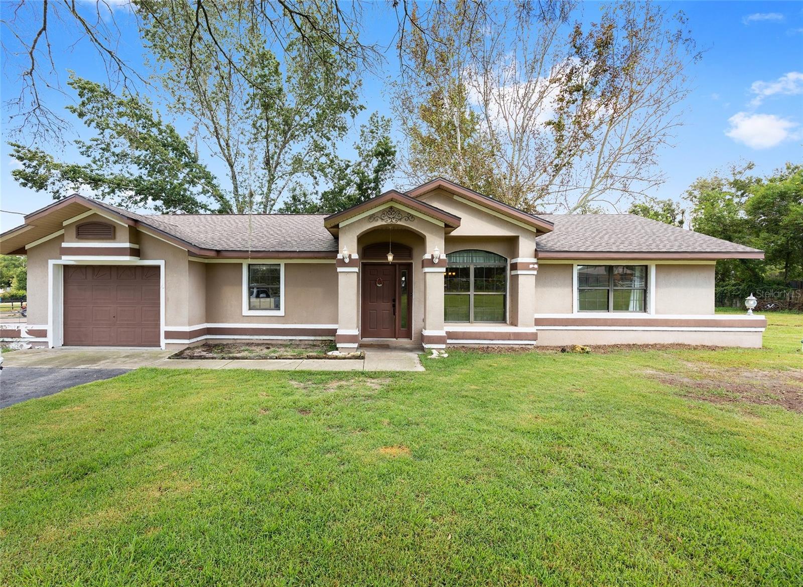 Welcome to this unique 2-bedroom, 2-bathroom home located on a 1.87-acre corner lot perfect for those seeking space, privacy, and an equestrian lifestyle. Inside, the home features a split floor plan, comfortable living areas, laundry room, and a spacious sunroom—perfect for enjoying natural light year-round while staying protected from the elements. An extra room adds flexibility for a home office, guest space, or hobby room. Roof was replaced in 2023. This equestrian-ready property includes stalls, paddocks, riding arena and a tack room for gear and storage. Offering ample space for animals, gardening, or future additions. Plus, this wonderful property is just a short drive to the World Equestrian Center