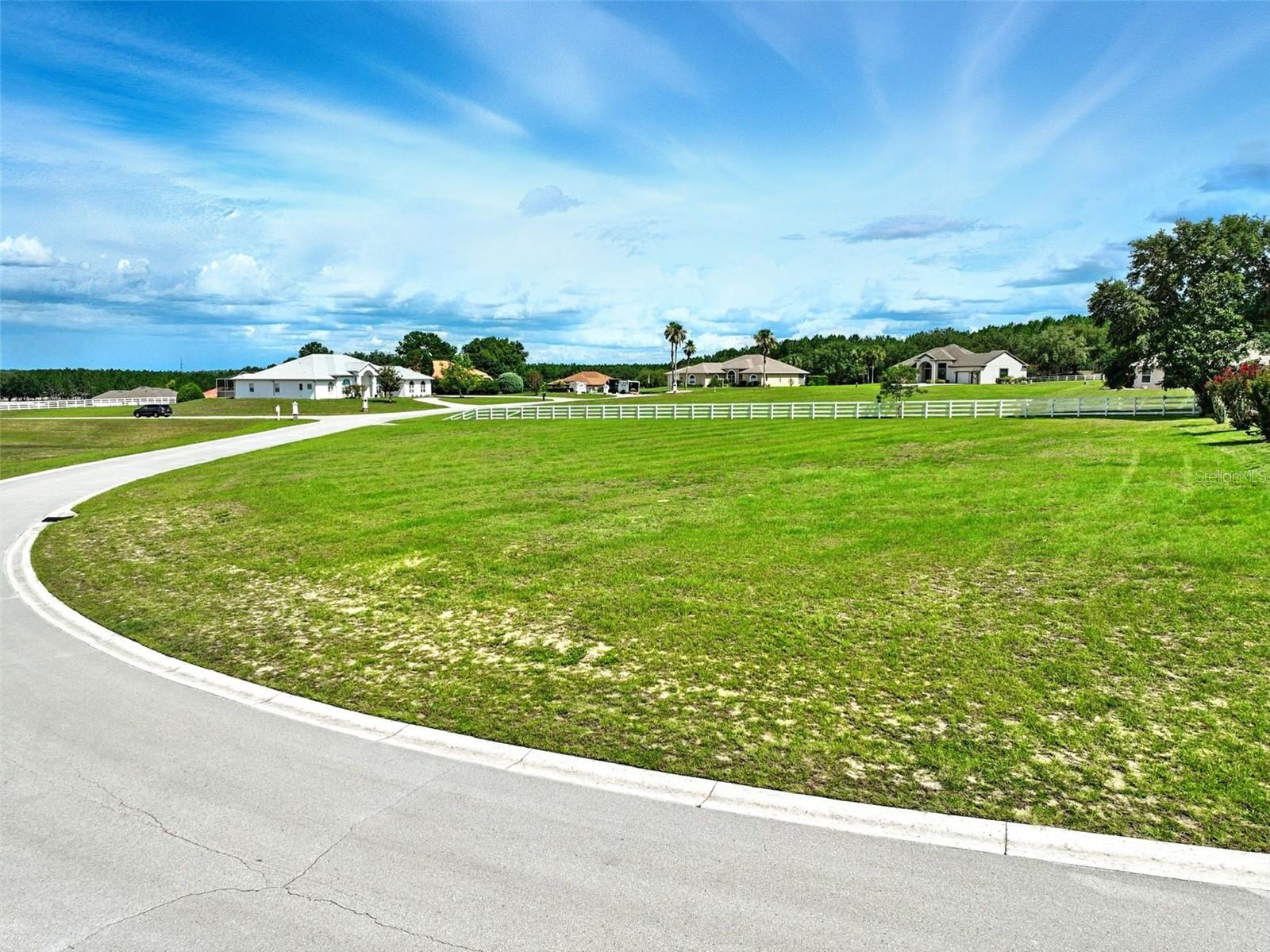 Discover a rare opportunity in the charming Citrus Hills community—a spacious 0.71-acre corner lot nestled in the desirable Belmont Hills neighborhood at 1274 E. Whirl Away Circle in Inverness, Florida. This expansive parcel offers ample room to design your dream home and outdoor living space while providing added privacy and flexible building options thanks to its highly coveted corner location. The lot is beautifully adorned with an elegant four-rail white horse fence, perfect for anyone seeking a classic country aesthetic. Surrounded by beautiful homesites, it offers an ideal setting for a serene, upscale custom estate.
As part of the Citrus Hills community, you’ll enjoy an impressive array of amenities, including multiple championship golf courses, tennis courts, a clubhouse, fitness center, swimming pools, and vibrant social events. Shopping and dining are conveniently nearby, with grocery stores, boutique shops, cafes, and restaurants along Citrus Hills Drive and U.S. Highway 41. Downtown Inverness, known for its scenic waterfront park, weekly farmers market, charming brick streets, local breweries, unique shops, and seasonal festivals. Outdoor enthusiasts will appreciate easy access to the Tsala Apopka Chain of Lakes for paddleboarding, kayaking, and boating adventures.
You’re also perfectly positioned for day trips to Ocala and its internationally renowned "Horse Capital of the World" located Northeast of Inverness. Crystal River, the Gulf of America and Nature Coast attractions are located just west of Belmont Hills. The Crystal River National Wildlife Refuge including Three Sisters Springs with its winter manatee shelter and viewing areas. For relaxing, visit Florida’s famed freshwater springs like Weeki Wachee, Rainboy, or Homosassa, offering crystal-clear swimming and abundant wildlife viewing. Whether you envision an country estate, a spacious lanai overlooking green space, or a sound investment in a premier Citrus Hills address, this lot offers the ideal canvas for your vision. Don’t miss this opportunity to own a slice of classic Florida living with equestrian charm, resort-style amenities, and unbeatable proximity to everything that makes the Inverness and Gulf Coast region special. Schedule your appointment today!
