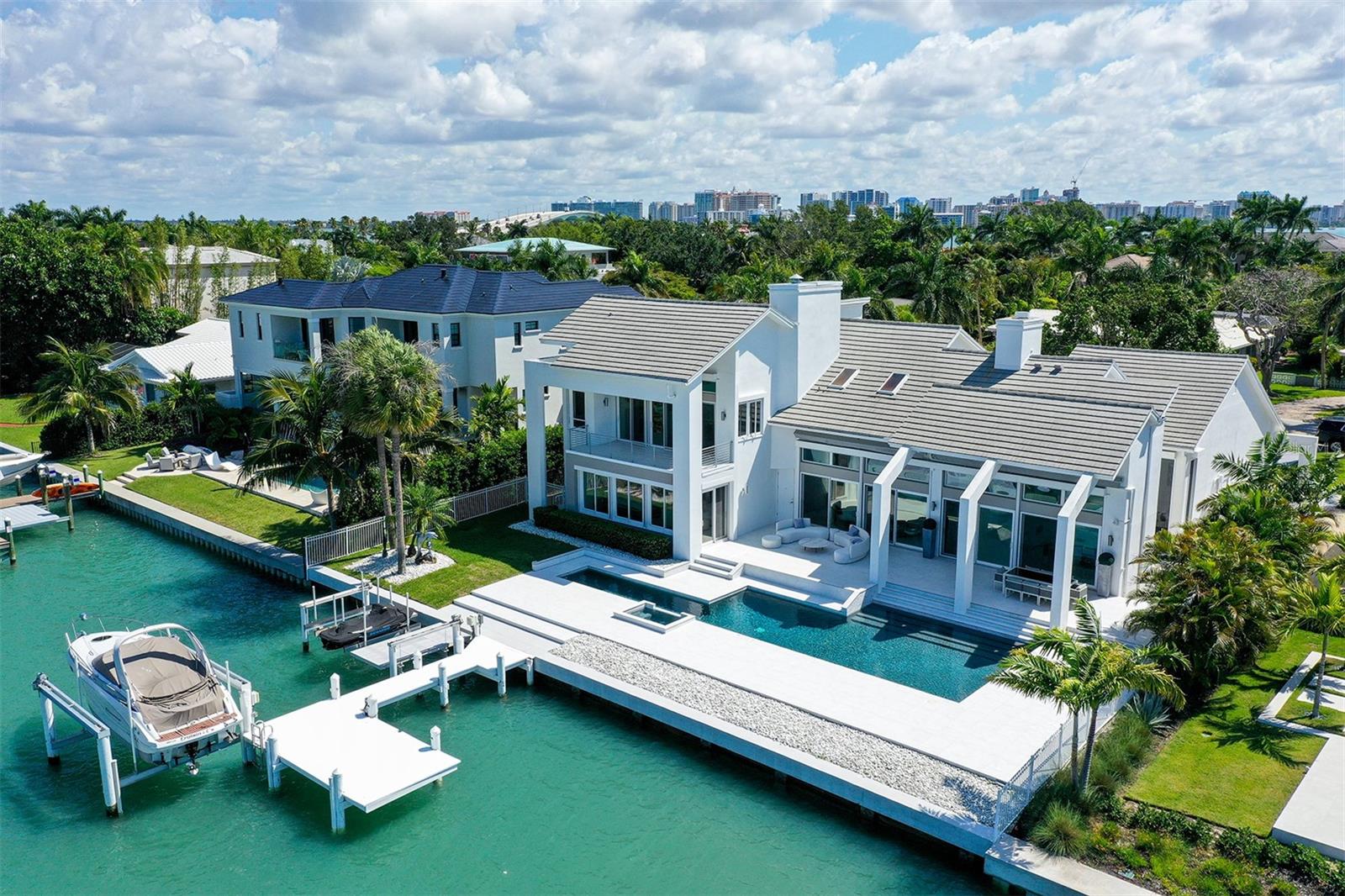 Under contract-accepting backup offers. Location! Location! Location! Live the life you’ve dreamed of on the Sarasota Bird
Key deep water bay! This western exposed home puts boating and water-sports at
your fingertips as it overlooks the prominent Sarasota Yacht Club and ushers in
unparalleled vistas and breathtaking sunsets while living only seconds away from St
Armand’s Circle, Lido Beach and Downtown Sarasota.
Spanning 5,267 sf, this 5-bedroom, 6-bath wide open plan is perfect for
entertaining! This home has an easy flow design from the front door all the way to
the bay and it’s being offered for an attractive price per SF of a narrow water canal
home. This savings gives you the opportunity to add your unique design touches to
make this home your own! If modern is your choice of style, this home is perfect, if
beach elegance inspires you, this home awaits your salty air touches and if a warm
moody sultry look appeals to your senses, this home is ready, fun and easy to
transform!
With this home, you really can have it all! Large open bay vistas, light-drenched
living spaces, high soaring ceilings and spectacular water views from most every
room. Plus, it’s the only Bird Key bayfront home available! This home is built strong
with hurricane windows, electric hurricane shutters, large swimming lap pool and
instills confidence in its structural integrity while electric shades over the pool deck
add a touch of sophistication. You’ll feel the beauty of nature flowing throughout
the entire home. The updated kitchen boasts sleek quartz countertops and
premium appliances, including a Bosch gas double seer stove, Bosch double oven,
Bosch dishwasher, and a professional wine cooler. Two large lavish owner's suites,
one on each level gives you and your guests room to relax! Step into your backyard
paradise where important upgrades abound. Completed in 2021, the outdoor
space features a stunning white porcelain paver pool deck with a modern swim lap
and saltwater pool design adorned with bullnose porcelain pavers lining the pool's
edge and steps, plus new waterline tile and new re-splendent royal blue
resurfacing.
The second-floor owner's suite deck, harmoniously unites the spaces and allows
you to unwind in style while overlooking your private dock fully equipped with a
14,000 lb. electric boat lift, two jet ski lifts, and an electric water platform, inviting
water enthusiasts to indulge and explore the open waters.
Recent enhancements include a new slate roof installed in 2018, three HVAC
systems, an electric Rheem hot water heater and a new 25 year warranty on the
plumbing/piping. Enjoy the pinnacle of the coastal life; bring your yacht and relish in
the luxury of Bird Key living, just a short walk or golfcart ride to Lido Beach, St.
Armands’ Circle and the vibrant downtown area with its exquisite restaurants,
theaters, and shopping. Don't miss the opportunity to make this exceptional
Sarasota gem your dream home.
