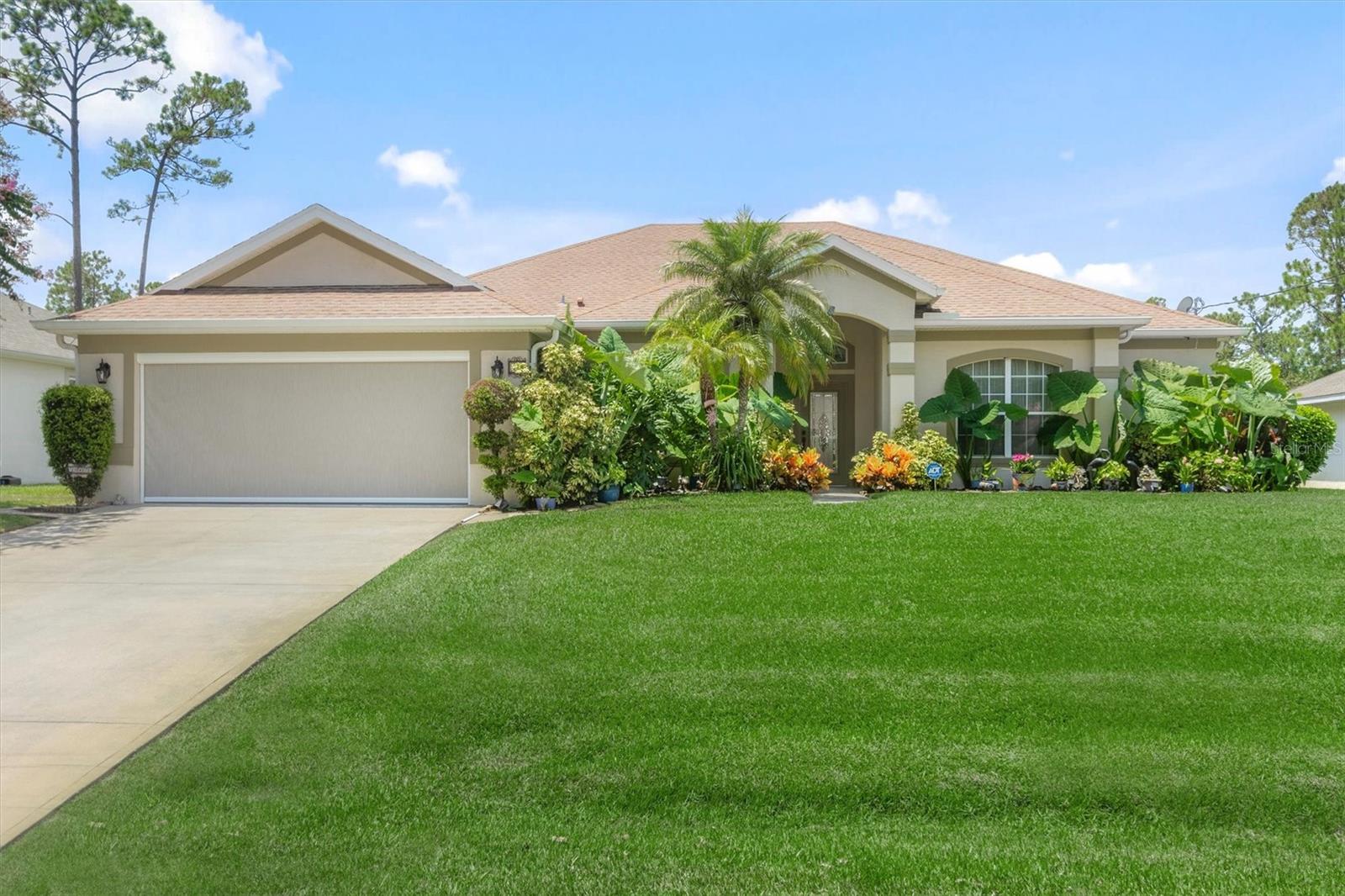 Tucked at the end of a quiet cul-de-sac in Palm Coast, this inviting 4-bedroom, 2-bath pool home is designed for both everyday comfort and effortless outdoor living. The open layout flows seamlessly between the living, dining, and family areas, creating a welcoming space for gatherings of any size. At the heart of the home, the kitchen is appointed with granite countertops, stainless steel appliances, a breakfast bar, and a walk-in–style pantry with custom shelving. The spacious primary suite is privately situated and offers direct access to the screened lanai. Outside, a sparkling saltwater pool is framed by a covered patio and screened enclosure—perfect for private relaxation or entertaining guests. The .25-acre lot provides ample room for play, gardening, or pets, with mature trees adding shade and privacy. A two-car garage and multiple storage areas add convenience, while thoughtful updates provide peace of mind. Centrally located near shopping, dining, parks, and everyday necessities, this home blends function, comfort, and the best of the Florida lifestyle.