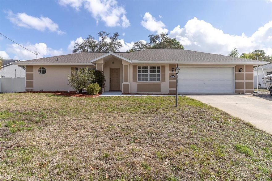 Enjoy the freedom of NO HOA and the space of nearly ¼ acre with this well-maintained home designed for comfortable everyday living. Step into the inviting living room with vaulted ceilings and sliding glass doors that open to a covered, screened lanai, creating a perfect space for relaxing or entertaining. The galley-style kitchen features a closet pantry, eat-in dining area and a convenient pass-through window to the lanai, making indoor-outdoor living easy. The split bedroom floor plan provides privacy for both owners and guests. The spacious primary suite features a walk-in closet and private ensuite bath. Bedroom 2 is located near a full bathroom that has been tastefully updated. An additional third bathroom with shower is conveniently located just off the laundry room near the garage, ideal for guests or quick clean-up after working outdoors. The laundry room includes a utility sink, cabinets, and additional storage. Outside, mature trees and landscaping create a peaceful, park-like backyard setting and also has a wood shed with a shingle roof for additional storage. Recent updates include a new ROOF 2026, A/C replaced in 2018, exterior paint in 2023, luxury vinyl flooring in the main living areas, and appliances replaced in 2018-19, making this home move-in ready. This property offers the perfect opportunity to enjoy gardening, hobbies, or simply relaxing in your own backyard retreat.