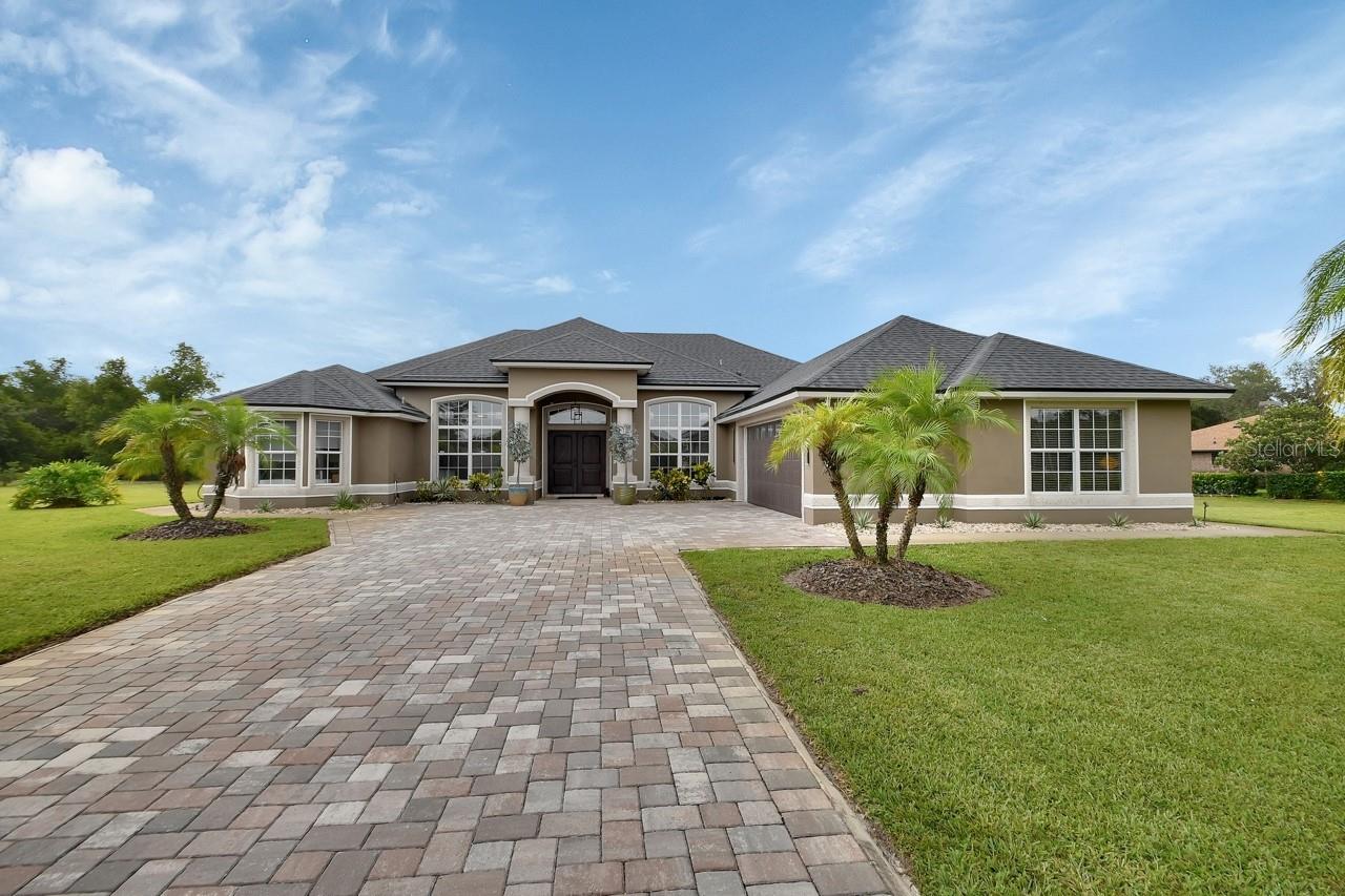 You won’t find another home like this! POOL Home on 1.5 Acres.
This spectacular 5-bedroom, 4-bath estate sits on a beautifully manicured 1.5-acre lot and has been completely updated—inside and out—with extraordinary attention to detail.
A gated entrance and elegant paver driveway welcome you to a grand double-door entry. Inside, the open, split floor plan offers both comfort and elegance with crown molding, tray ceilings, and ceramic tile throughout most of the home. The family room and 5th bedroom/flex space feature real hardwood floors, adding warmth and character.
The oversized primary suite is a private retreat with his and her walk-in closets and a fully renovated bath boasting a soaking tub, dual vanities, a beautifully tiled walk-in shower, and direct access to the pool and lanai.
The heart of the home—the kitchen—is a chef’s dream, featuring stainless steel appliances, solid wood cabinetry, an oversized walk-in pantry, a breakfast bar, and a sunny dinette that flows seamlessly into the spacious family room—perfect for entertaining.
Step through sliding glass doors to the screened-in lanai with summer kitchen, outdoor shower, and the 4th full bath, all overlooking the sparkling pool—ideal for Florida living. The backyard offers peaceful serenity with a custom sitting area by the pond, perfect for enjoying sunset views or morning coffee.
Additional features include:
• Detached storage shed for lawn and garden tools.
• Covered parking for extra vehicles, RV, boat, or toys.
• Full solar system (can be paid off at closing for energy efficiency)
• All major systems replaced within the last five years.
Ideally located just 15 minutes to I-4, with easy access to Orlando airports, Daytona Beach, and the historic charm of Downtown DeLand, home to Stetson University.