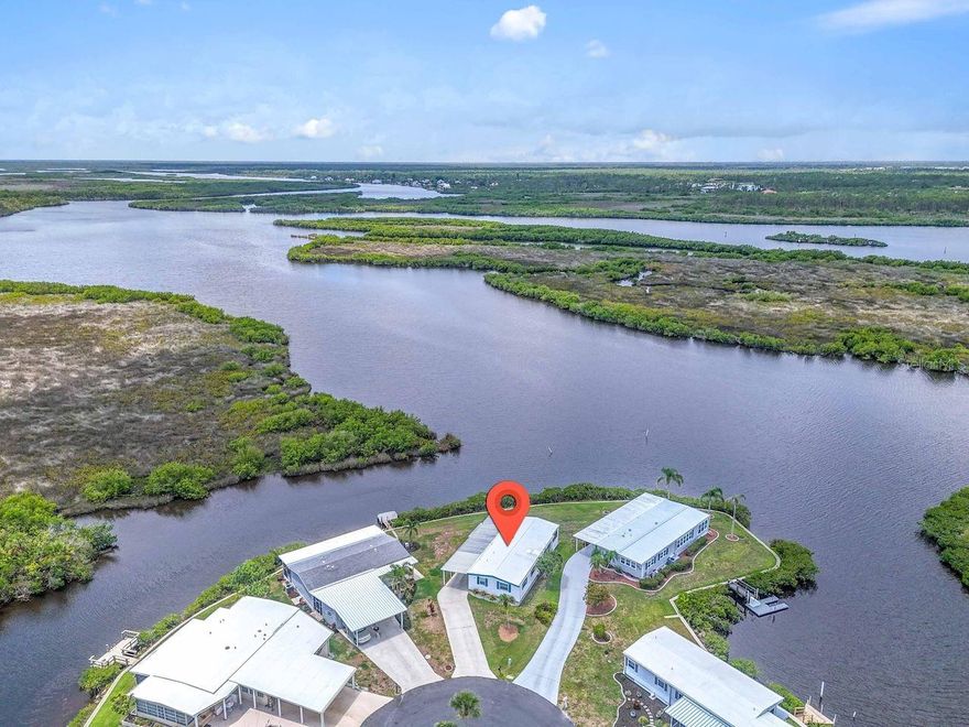 Prepare to be captivated by INCREDIBLE RIVER AND CANAL VIEWS! This charming 2 bedroom, 2 bath residence is located in a premier location within the 55+ waterfront community of Harbor Cove with GULF ACCESS. Rarely do homes with direct Myakka River views become available. This fully furnished home has 1056 square feet of living space plus an additional 256 square foot enclosed lanai with large windows that offer a deep connection with the natural surrounding beauty. Observe wading birds flocking to the their nesting grounds each evening and keep an eye out for dolphins, manatees, fish and more. Inside, the coastal style adds a relaxing seaside vibe with two comfortable bedrooms and two bathrooms plus a large inviting living room offering views of both the river and canal. The kitchen has plenty of counterspace and all necessary appliances including a dishwasher, with convenient dining area nearby. Outside is a large open backyard with seawall maintained by the HOA, plus a covered patio for entertaining friends, enjoying evening beverages or just watching all the boats cruise by on the main canal that accesses the marina. A huge shed holds the washer and dryer and the long driveway provides space for all your vehicles. The property has had several updates including a new AC system installed in 2024. Boating and fishing fans will be thrilled over the option to rent a boat slip at the marina for only $100 per year! Other amenities offered are two swimming pools, hot tub, large two-story clubhouse, fitness center and a variety of sports courts. Stay active and make new friends at the dances, block parties, picnics, classes, games, and various clubs. All of this is offered with unbelievably low HOA fees of just $150 per month. Located close to casual restaurants, waterfront dining, several area beaches, diverse shopping options, beautiful parks, spring training stadiums, and quality medical services. Don't miss this rare opportunity! Schedule a private showing today.
