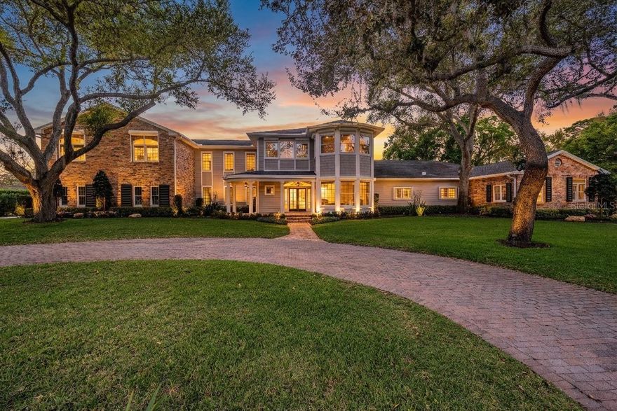 Timeless architecture, exceptional craftsmanship & refined luxury living in Palm Harbor! Perfectly positioned on a private cul-de-sac in the prestigious community of Cobb’s Acres, this stunning 5,700 square-foot estate is coming to market for the first time after being meticuliously redesigned to the highest standards of modern luxury. A charming brick path welcomes you to the covered front porch where peaceful views of Lake Tarpon create a tranquil setting. From the moment you enter through the double French glass doors, the home unfolds with elegant features, designer finishes, and beautifully curated spaces - details rarely found in today’s homes. The foyer flows into the formal living room, music room, & formal dining room, & also features a powder bath highlighted by a hand-carved Italian marble sink. A gracefully arched hallway leads to the heart of the home: a stunning great-room-style living area designed for both everyday living & refined entertaining. This wing features an oversized living room, spacious dining area, & a chef’s dream kitchen. Floor-to-ceiling custom cabinetry surrounds a professional appliance suite; a 60-inch Wolf gas range with double ovens, pot filler, & custom hood, along with a Sub-Zero refrigerator & freezer, Miele dishwasher, Scotsman ice maker, & a custom coffee bar. A beverage station with wine fridge & custom built-in pantry provides optimal functionality. Adjacent to the main living space is an oversized bedroom or bonus room, a full bathroom w/ walk-in shower near the pool, & perfectly placed closet designed for laundry or addt'l utility. White oak flooring runs throughout, complemented by custom wainscoting & crown molding. Generous closet space throughout the home provides exceptional storage & organization. Sconce lighting lines the hallways and leads to the upper level where five of the bedrooms are located. At the top of the stairs, the main laundry room offers abundant cabinetry & storage. Two bedrooms share a beautifully designed marble bathroom featuring dual sinks, a large walk-in shower, private water closet, & custom cabinetry. Two add'l bedrooms each feature private en-suite bathrooms - One w/ a soaking tub & shower combination finished in marble, while the other offers an arched walk-in shower with oversized wood vanity. Down the hallway, an arched entryway introduces the private primary wing, complete with a color-drenched office flooded with natural light. Enter the primary retreat through 8 foot white oak solid doors, revealing a sanctuary designed for relaxation. The primary bath centers around a soaking tub & includes dual vanities with custom cabinetry, large walk-in shower, & a private water closet with a Toto fixture. The primary closet offers exceptional storage, custom lighting, & a steam closet for added convenience. The outdoor spaces complement the home beautifully - a large rounded patio reflects the timeless distinction, while the covered porch provides a relaxing place to gather or unwind. The pool area is perfectly suited for Florida living, & the spacious private backyard offers room for outdoor enjoyment or recreation. The yard behind the home previously housed a batting cage for the baseball enthusiast. An oversized 3 car garage fits large vehicles while still offering space for storage, equipment, & recreational toys. Ideally located near award-winning Gulf beaches, championship golf courses, premier dining & shopping, Tampa Intl Airport, & downtown Tampa.