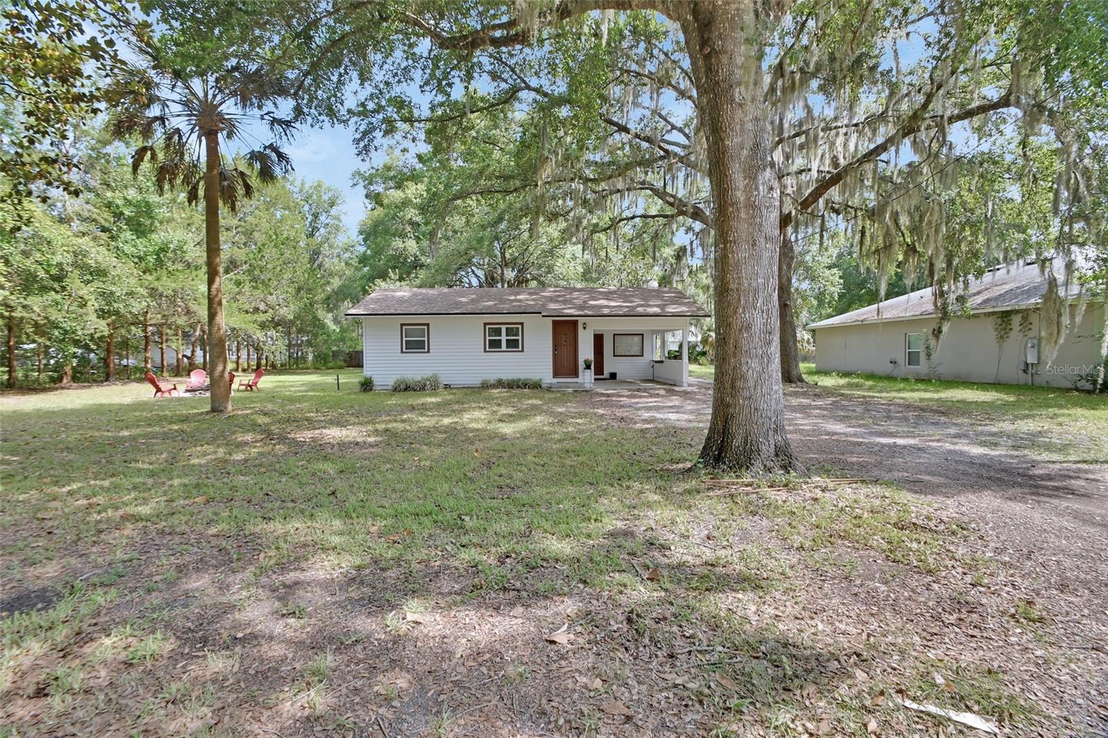 IMPROVED PRICE! Charming Lake Helen Bungalow nestled on large .33 Acre lot. This 2BR/1BA/ 1 car carport the home also has a large bonus room that serves great as a Florida room with beautiful views of the peaceful back yard. Hardwood/pine floors in most areas adds to this homes charm.
Newer roof 2022 HVAC 2019 even has newer efficient double pane windows, updated bathroom…. Ready for a quick closing and occupancy! Country setting with city convenience! Close access to I4 and just a short drive to award winning Downtown DeLand.
