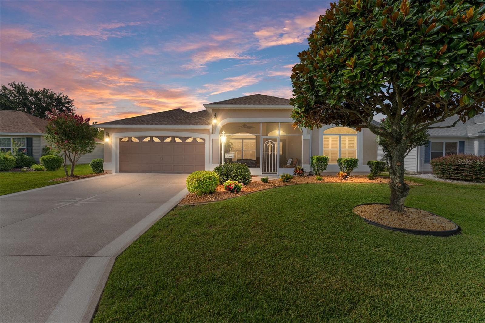 You've been looking for a Designer Model (Expanded GARDENIA) with Premiere upgrades and priced to sell! Look no further as this desirable model in a very convenient location near LAKE SUMTER LANDING and Hwy 466 is for You! Updated and refreshed- ROOF 2021, HVAC 2019, HWH 2019 and NO BOND!! Freshly painted inside and tile professionally cleaned- MOVE IN READY and NO CARPET! Residents love the Gardenia for it's open plan and split bedrooms for added privacy.
The curb appeal is so inviting with recently painted exterior/trim, painted driveway, and manicured trees and shrubs. You initially enter into a large Screened Front Porch (165 sf) which allows for relaxing amidst the beautiful landscaping or entertaining guests. As you enter the home you'll notice the vaulted ceilings, rounded wall corners and luxury upgrades. There is extensive CROWN MOULDING and PLANTATION SHUTTERS throughout. There is NO POPCORN, TWO SOLAR TUBES and updated Ceiling Fans and Fixtures.
The kitchen boasts beautiful Corian countertops, painted Cabinets, and STAINLESS STEEL newer appliances. And bonus- there's GAS HOOK-UP available for the stove and the dryer!! There is under/over cabinet lighting and roll outs in the cabinets for easy access. The Dining/Living Room area is extra large for entertaining and comfortable seating with a gas fireplace for ambiance. The Primary Bedroom has beautiful laminate flooring, vaulted ceiling, two walk in closets and a large en-suite with updated walk in shower and DOUBLE SINKS. The guest room has an Oversized Closet and is very inviting and bright. The 3rd bedroom or den (no closet) is set up as an office and has a Murphy Bed for additional guests. There is a convenient bathroom between these two bedrooms as well as a linen closet.
Wait until you see the Florida Room which provides extra space for whatever you may need. It's a seamless transition from the living area and adds extra square footage. There is a door which leads out to the back porch with Privacy and an ELECTRIC AWNING for shade and comfort. The Laundry Room with a newer Washer (2024) & Dryer (2015) and laundry sink leads to the Garage which has storage, attic stairs and decking and a water filtration/softening system with filters recently changed. Irrigation meter in the garage has been recently replaced with WiFi accessibility and a whole house surge protector.
This home has been so well maintained and recently updated and refreshed! It is on a quiet street and in a very socially active neighborhood that you will just love! This location is a mile from Lake Sumter Landing for entertainment and dining as well as two pools, golf, and a nearby recreation center. The furniture/decor and golf cart are available with a separate purchase. I can't wait for you to see it!!