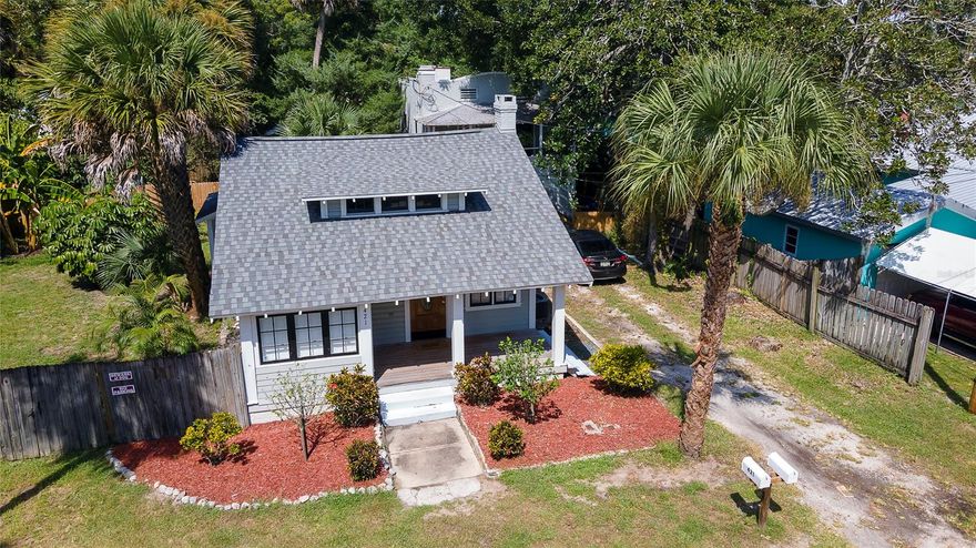 This is a charming classic Florida Cracker style home with a separate building, totaling 2 units.  Both units are on separate meters. The attic has the potential for additional living space. Stunning wood floors, fireplace, and open floor plan in the 2BR/1.5BA front house. The first floor of the garage in the back building can be built to liking. The upstairs garage apartment is ready to go!  Complete with its own laundry in the bathroom. Both buildings have new roofs and the main house has a new central AC. Both buildings have a private yards split by a newly put up fence. ;Water: City