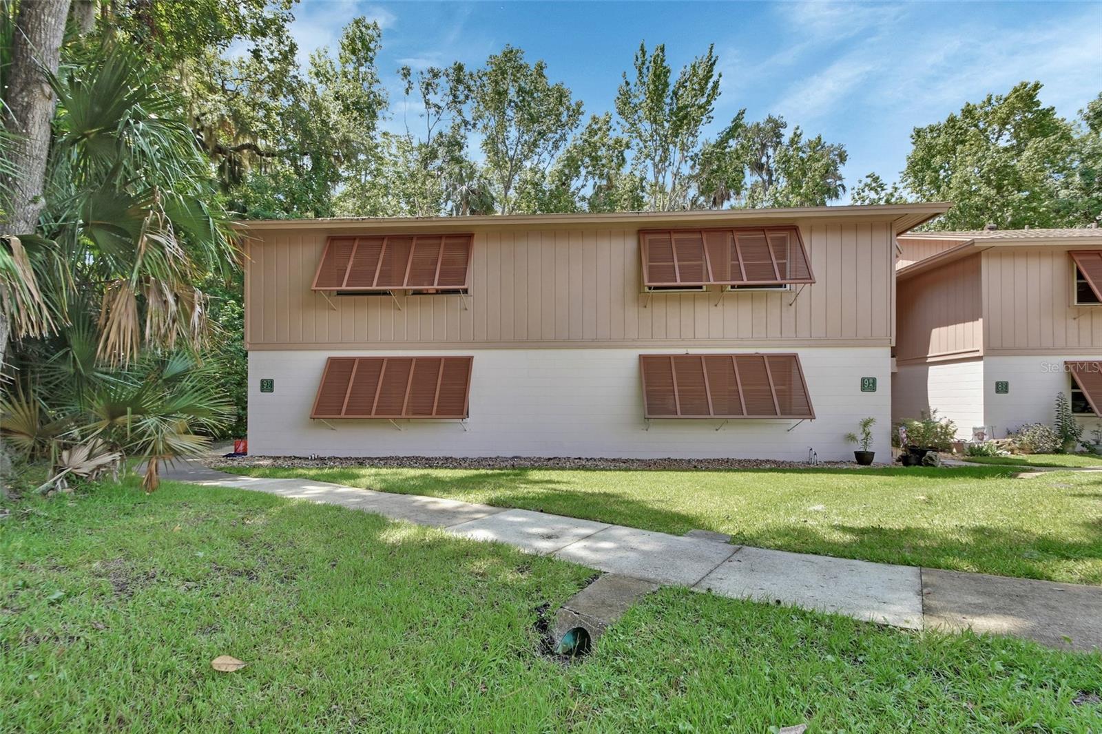 Charming 2BR/2BA First-Floor End Unit in 55+ Condo Community. Enjoy Private & Maintenance-Free Living!
Welcome home to this beautifully updated 2-bedroom, 2-bathroom condo, ideally located on the first floor with end-unit privacy and serene greenbelt views. This low-maintenance gem offers comfort, style, and convenience in one of the most private spots in the community.
Step inside to find wide plank laminate flooring throughout (no carpet!) and oversized marble-style tile in the kitchen. The kitchen features stainless steel appliances, custom solid wood cabinetry, a built-in wine rack, and a glass tile backsplash that adds a modern, sophisticated touch. Enjoy sitting on your screen-enclosed back porch, which opens to a peaceful buffer area—your own private oasis for morning coffee or evening relaxation. Double sliding glass doors bring in beautiful natural light and connect indoor comfort with outdoor tranquility.
The community offers wonderful amenities including tennis courts, a bike trail, clubhouse, pool, and pickleball courts, giving you plenty of ways to stay active and connected just steps from your front door.
Located in a sought-after area, this home is convenient to I-4, offering easy access to Orlando, shopping, dining, and the beaches.
If you’re looking for a move-in-ready home that combines privacy, thoughtful upgrades, and community living, this condo is a must-see. Schedule your private showing today!