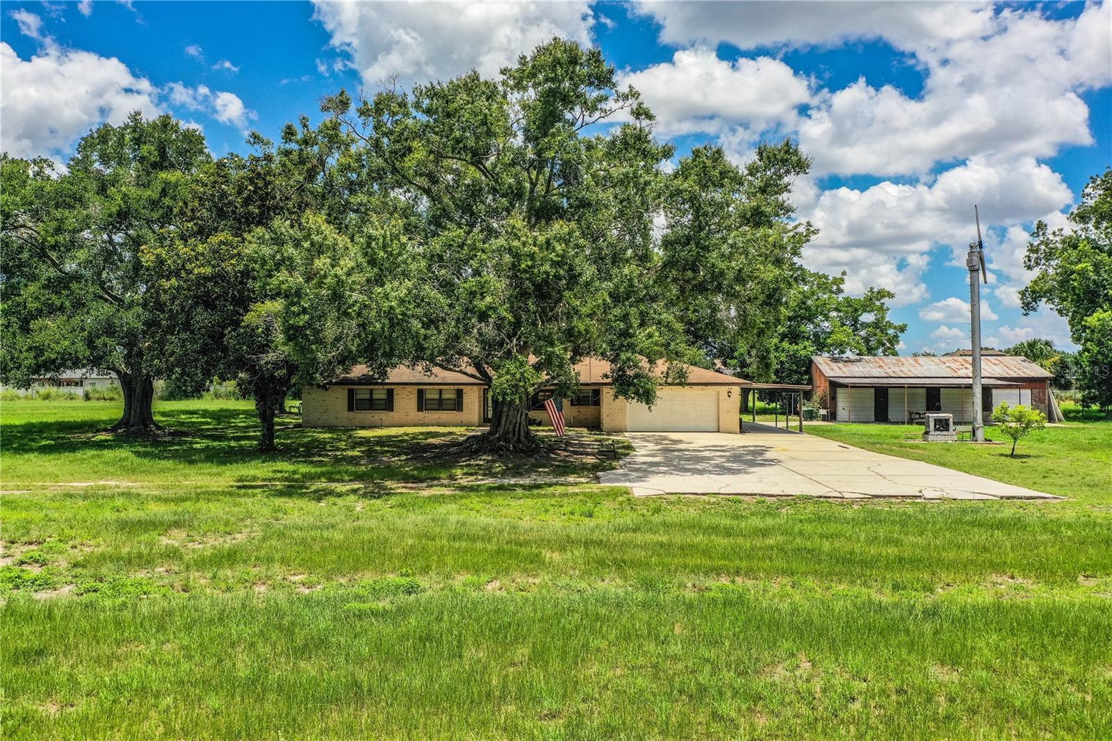 Auction Property. AUCTION! 10AM, Saturday, Sept. 13th.
Secluded 4-Bedroom Ranch on 5 Acres with Pool, Barns & Country Charm!
Discover the perfect blend of privacy, convenience, and space with this 4 bedroom, 2.5 bath ranch-style home nestled on 5 acres in East Winter Haven. Tucked away at the end of a quiet road, this former citrus grove
offers a peaceful, no-HOA lifestyle with plenty of room for your family, animals, and hobbies.
Built in 1979, the home features 2,000 sq ft of living space (3,050 sq ft under roof) including a formal
living and dining room, a spacious family room with a cozy fireplace, and a screened-in back porch
overlooking an in-ground swimming pool—perfect for Florida evenings.
Enjoy the added value of a 30’x60’ pole barn with concrete floor and a 24’x30’ enclosed storage
barn—ideal for equipment, workshop space, or recreational vehicles. Located just minutes from Hwy 27
and I-4, and right next to the new Publix shopping center and Winter Haven Country Club on Lake
Hamilton.
No HOA, no flood zone, and no compromises—this property is a rare find for those seeking space,
seclusion, and convenience!